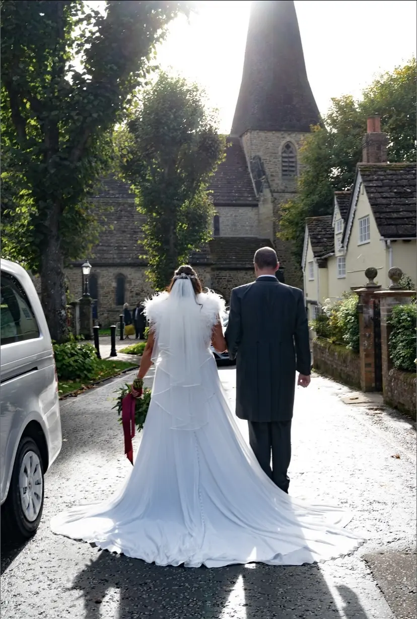 Bride Wearing Chiffon Lace Wedding Dress Called June By Maggie Sottero Walking With Groom Outside