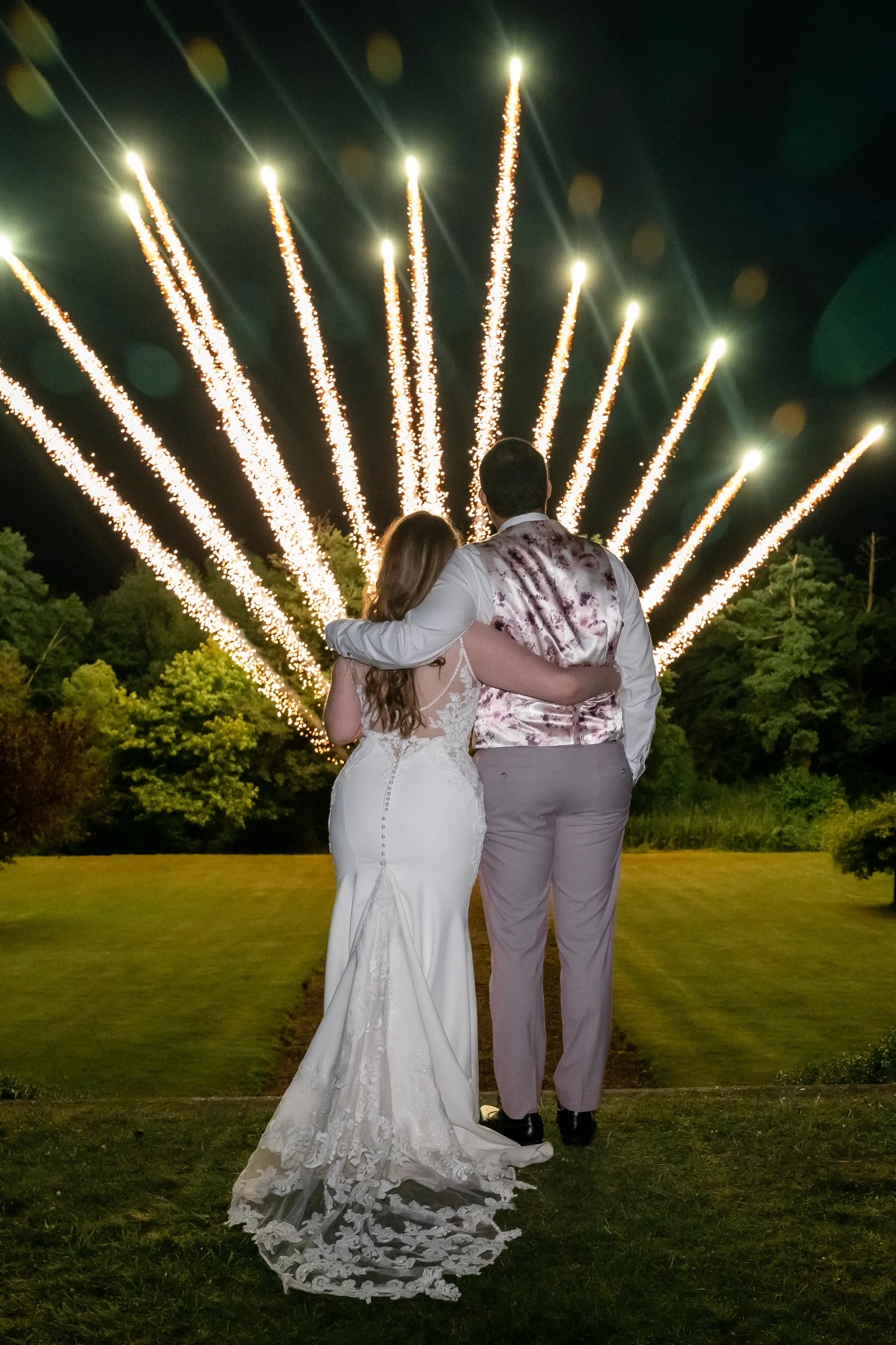 Bride wearing Nikki by Maggie Sottero and her husband watching fireworks