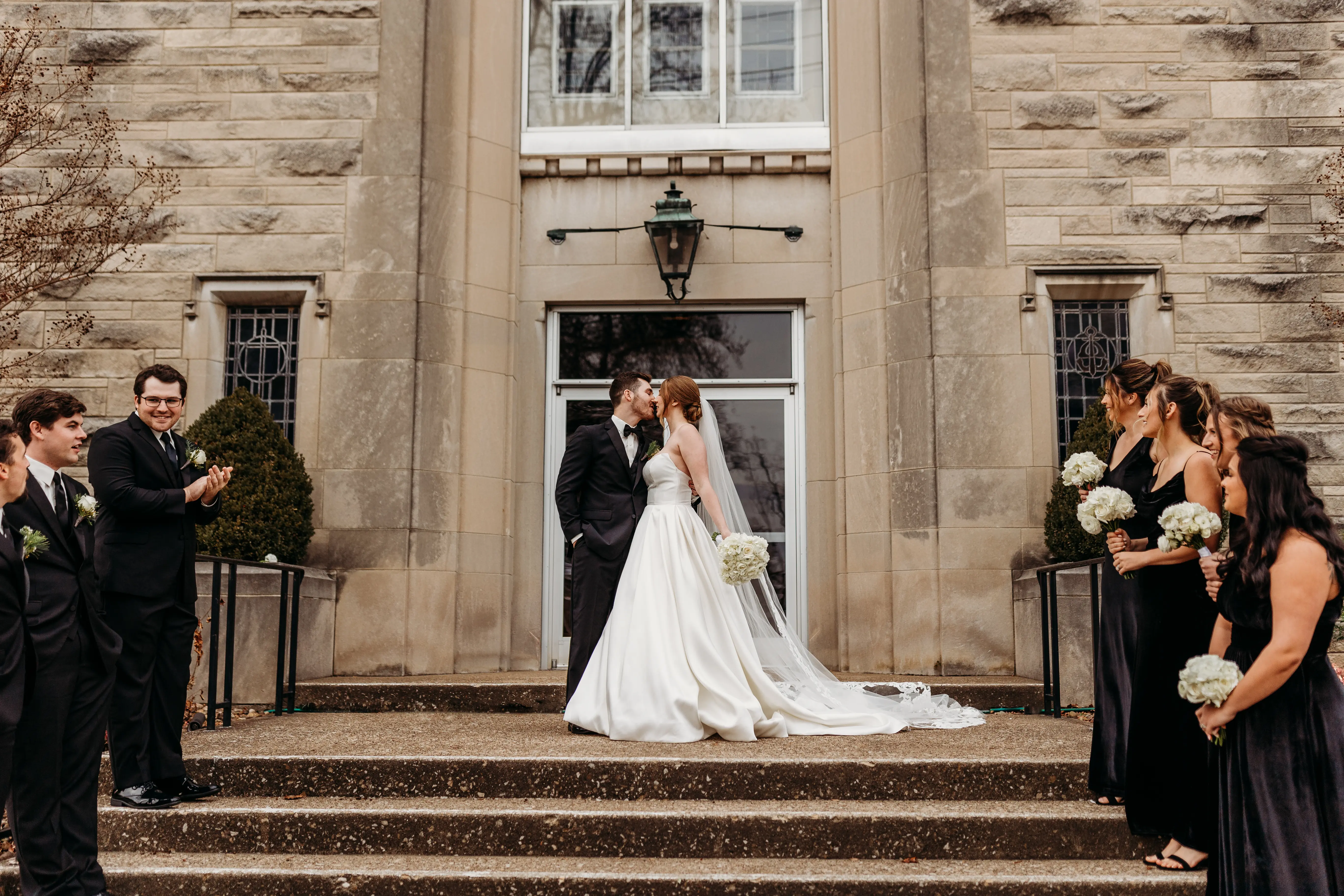 Groom Kissing Bride Wearing A Strapless White Wedding Dress Named Selena By Maggie Sottero