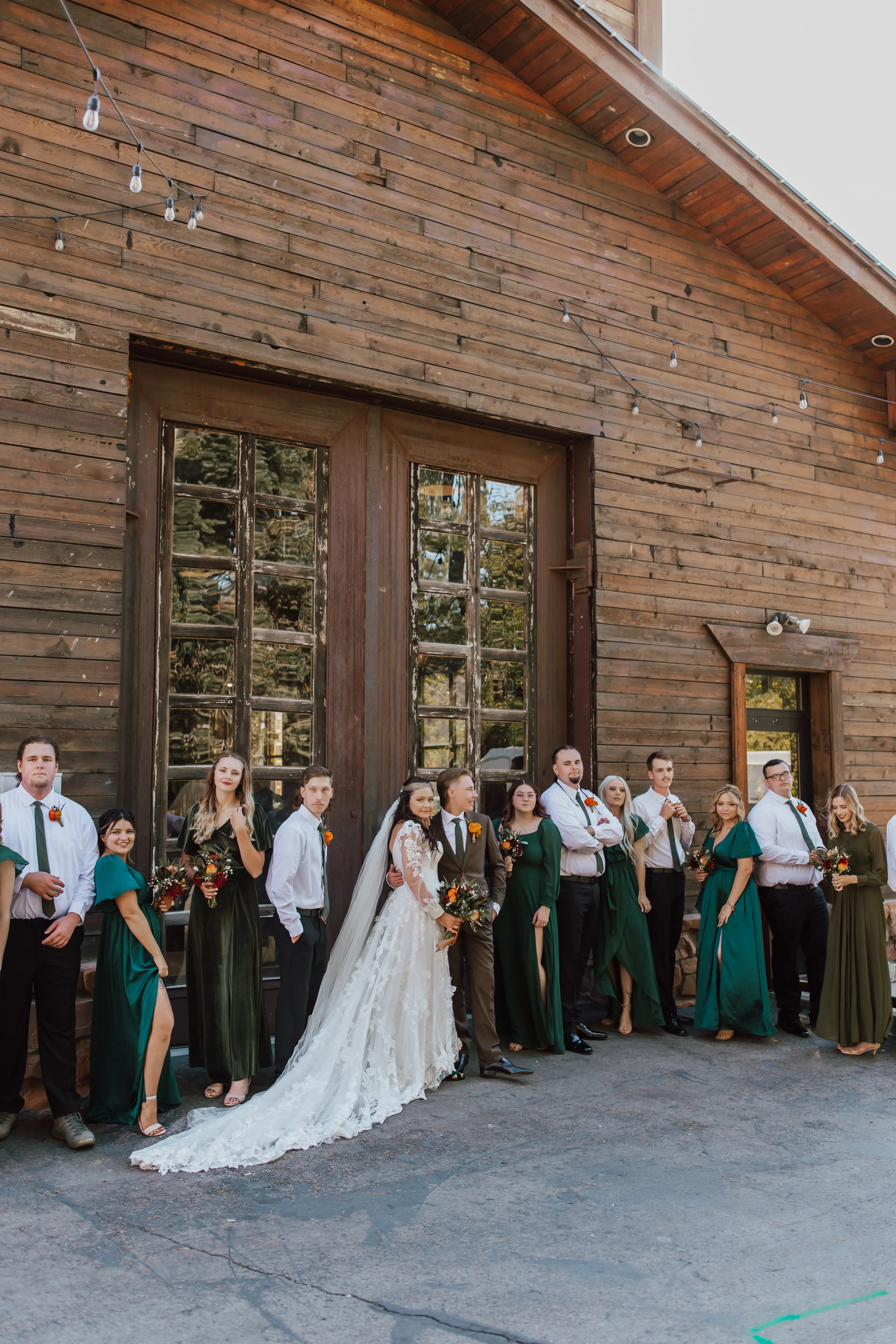 Wedding Party Standing Together. Bride Wearing Sparkly Modern Ball Gown Wedding Dress With A Mikado Bodice Called Greer By Maggie Sottero