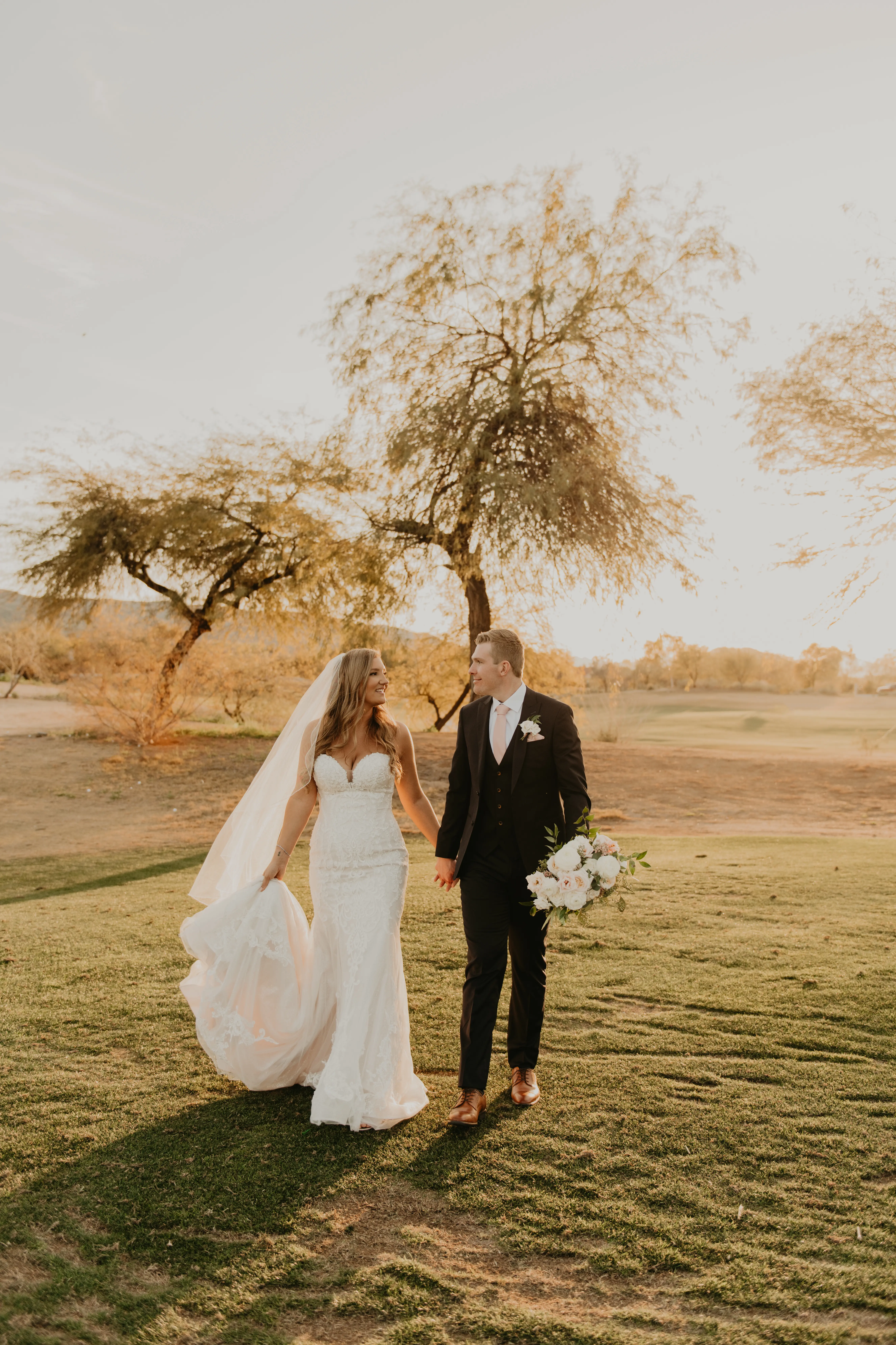 Bride Carries the Train of Elegant Mermaid Wedding Dress Frederique by Maggie Sottero
