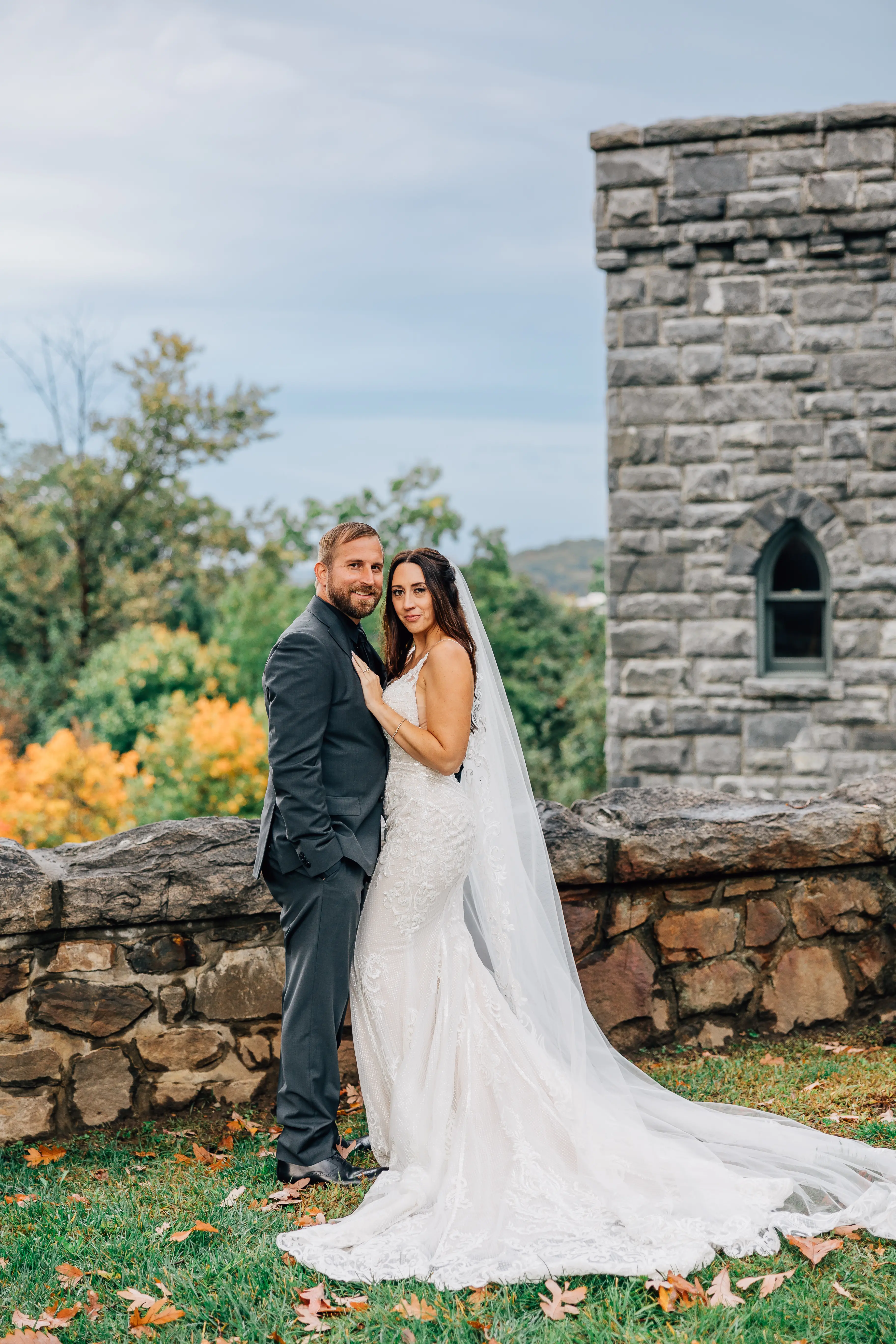 Groom Posing With Real Bride Wearing A Vintage White Wedding Gown Named Veronique by Maggie Sottero