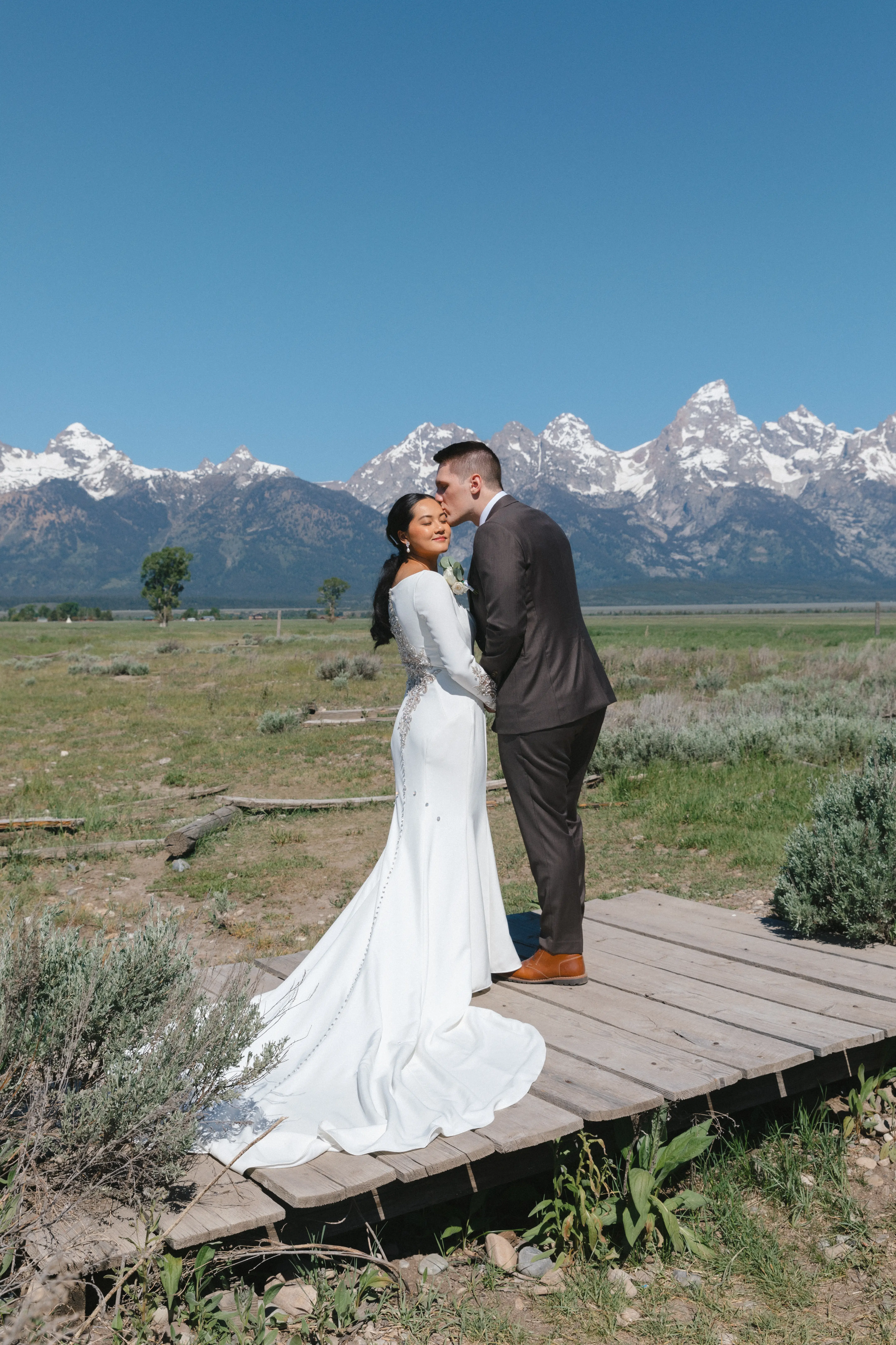 Bride wearing Aston by Sottero and Midgley being kissed by her husband
