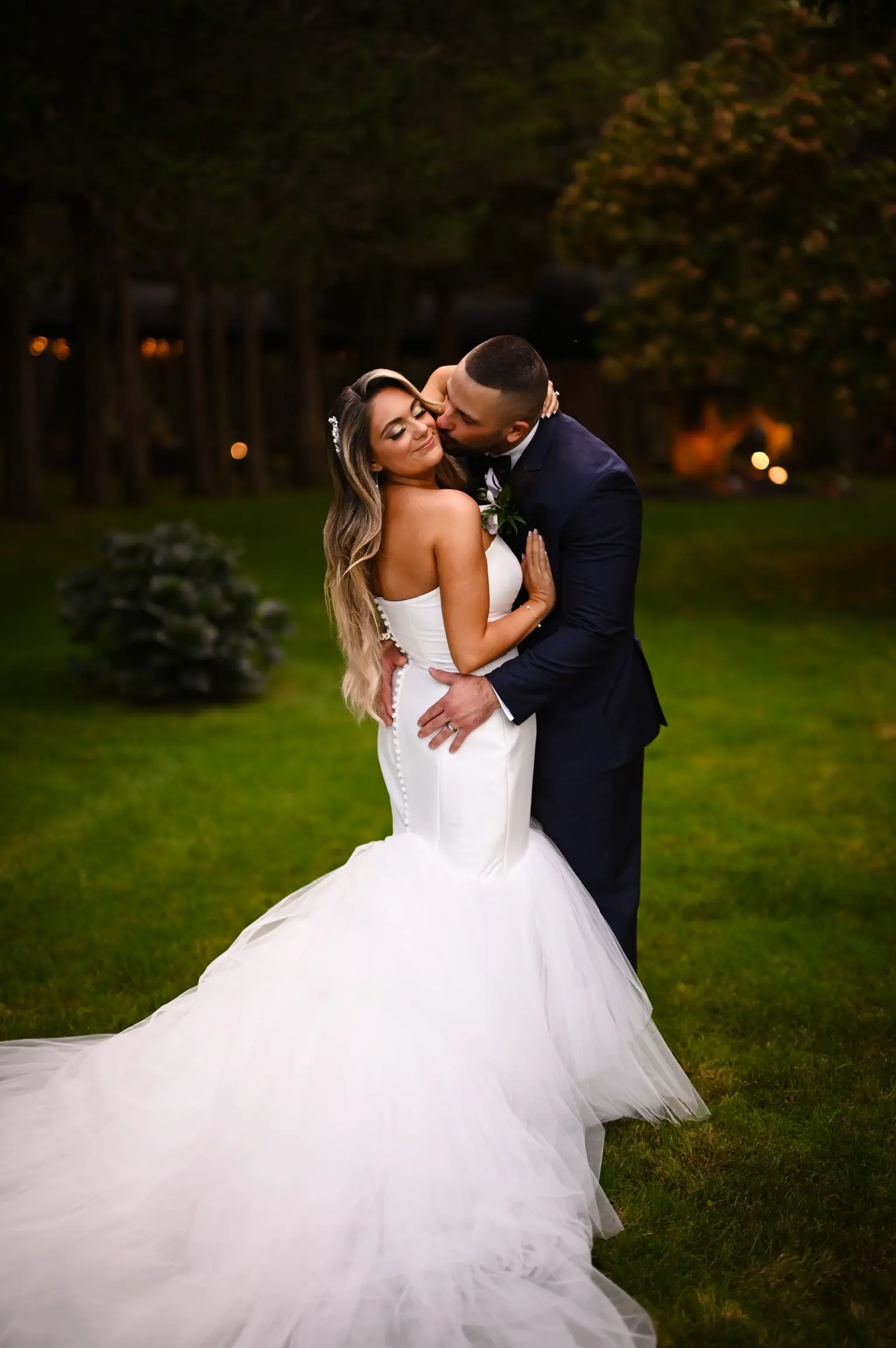 Bride wearing Holden wedding dress by Sottero and Midgley being kissed by her husband