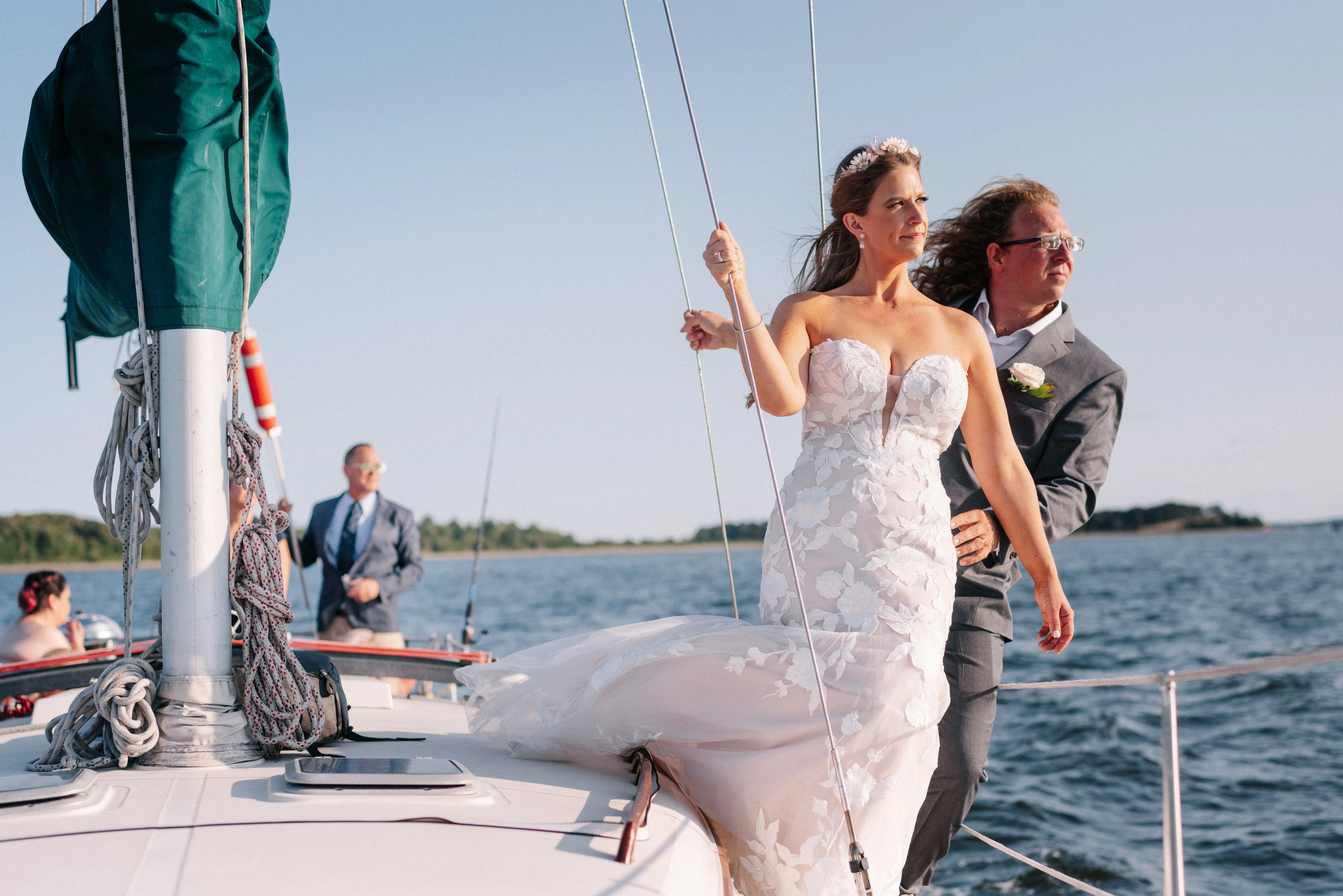 Bride with groom wearing strapless mermaid wedding dress with plunging V-neck.