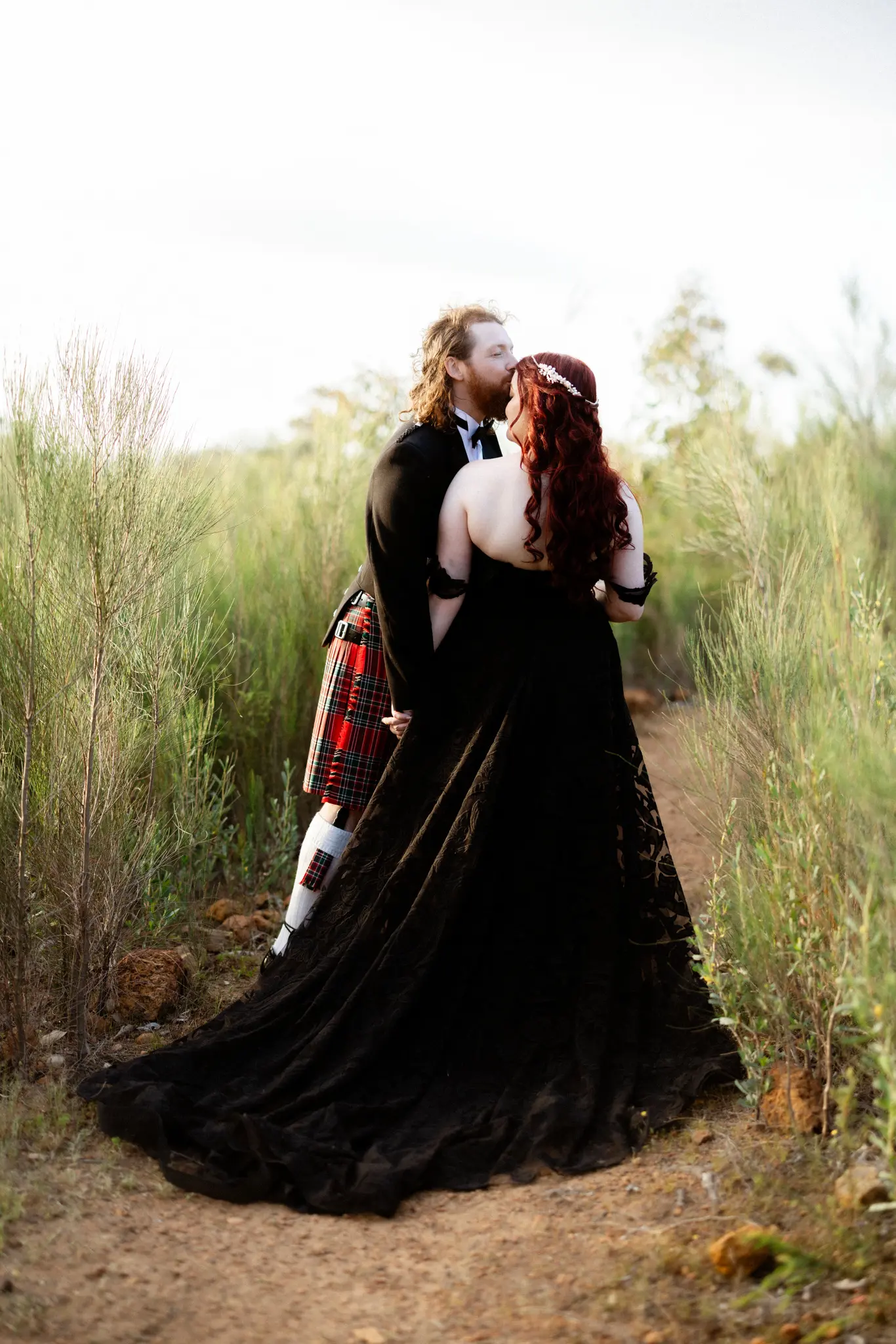 Bride Wearing Black Lace Wedding Dress Called Penny By Maggie Sottero Kissing Groom