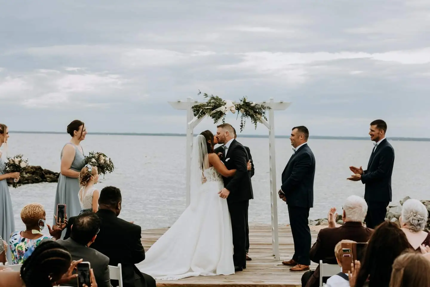 Bride Wearing Flirty A-line Wedding Gown Called Savannah By Maggie Sottero Kissing The Groom