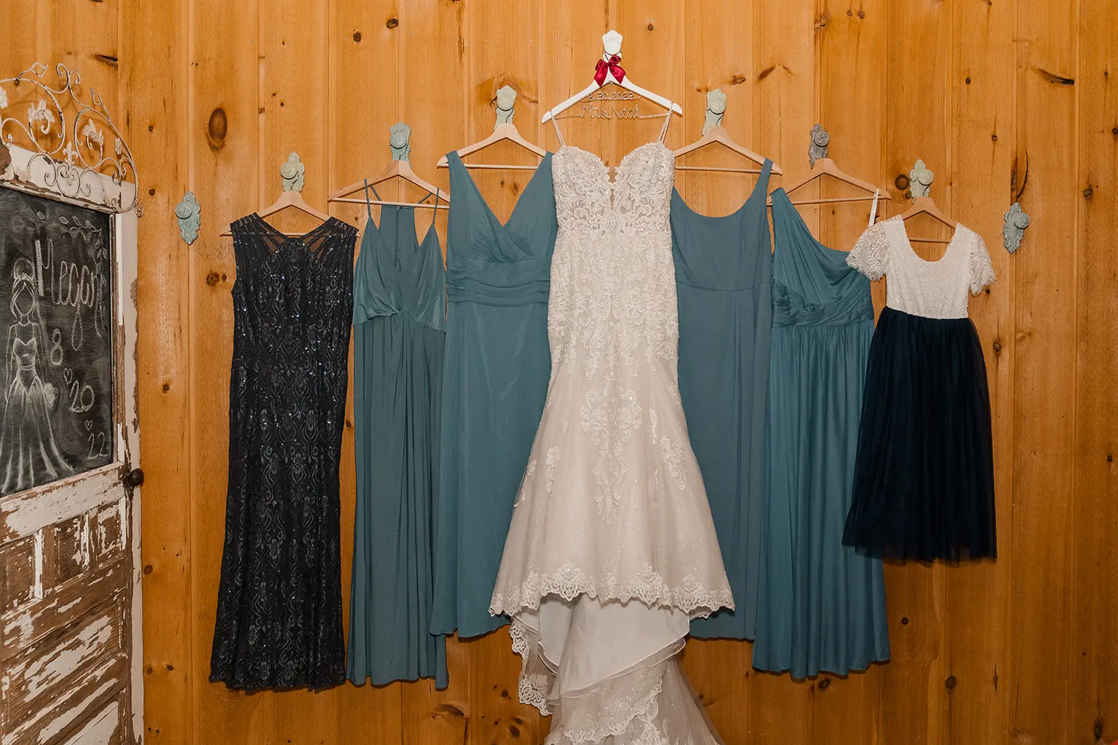 Sexy Mermaid Lace Wedding Dress Called Fiona By Maggie Sottero Hanging On A Wall With Bridesmaids Dresses