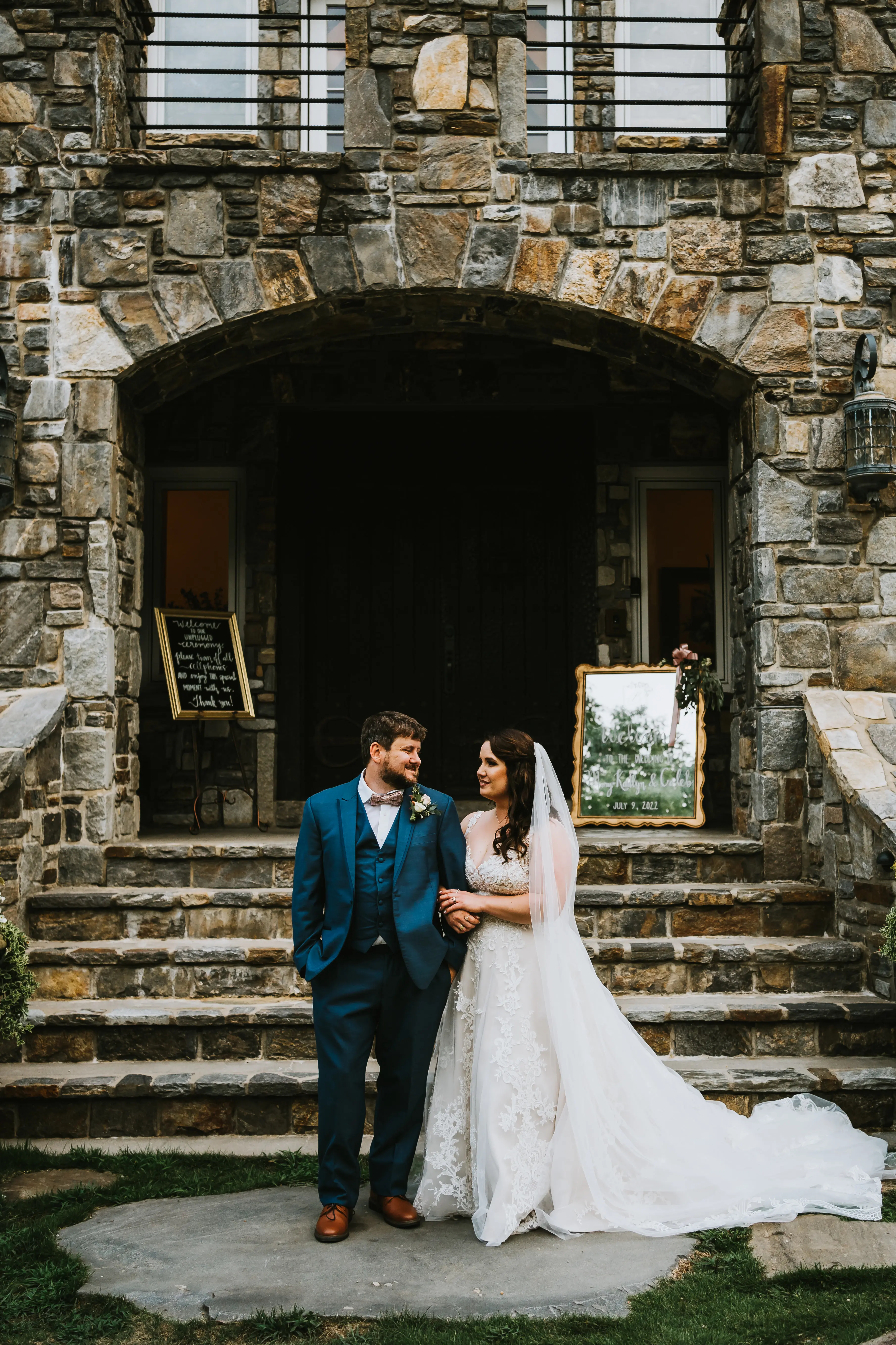 Bride Wearing Shimmery Princess Bridal Gown Called Tiffany By Maggie Sottero With Groom In Front of Reception Hall