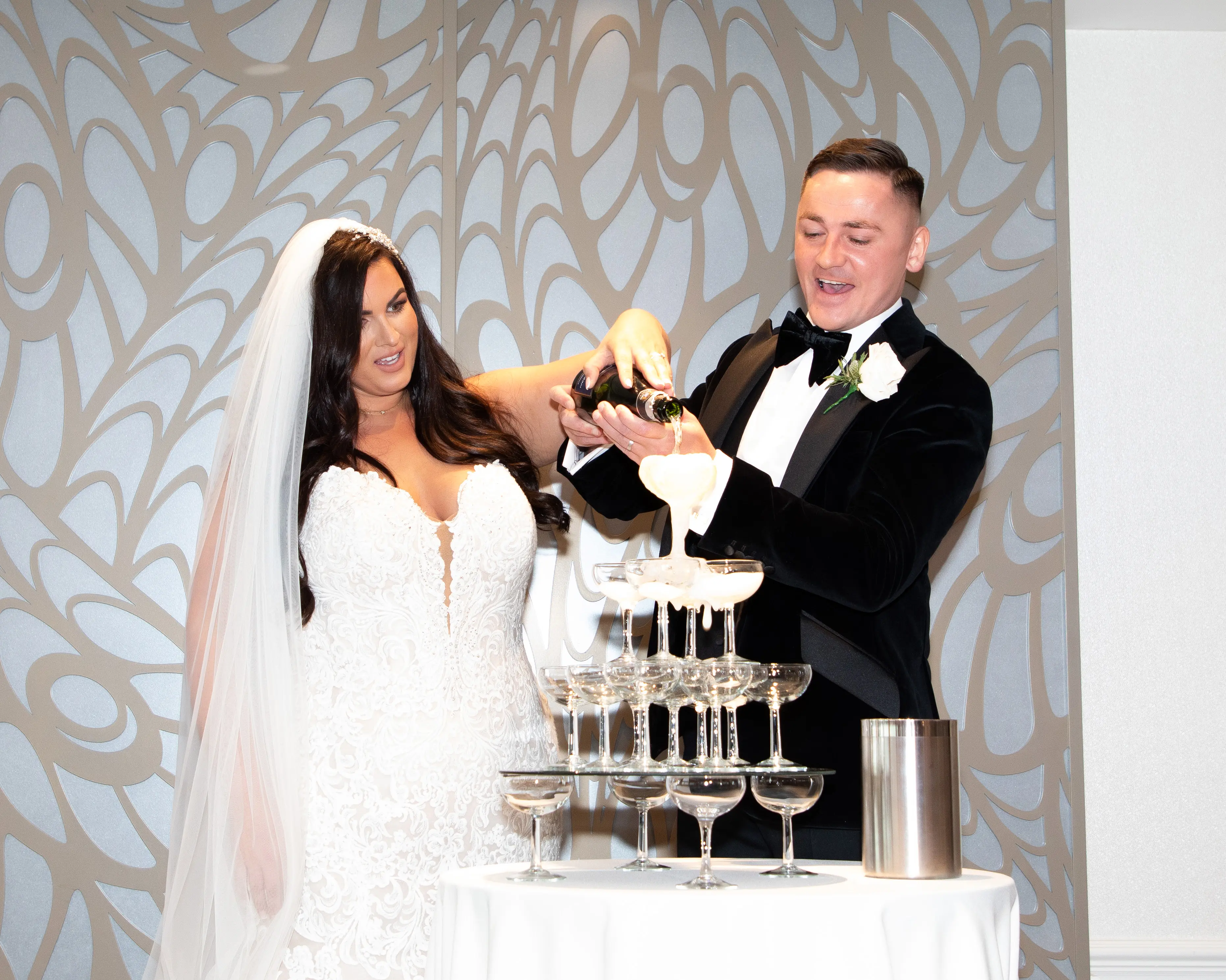 Bride in lace motif wedding dress called Alistaire by Maggie Sottero with groom at reception