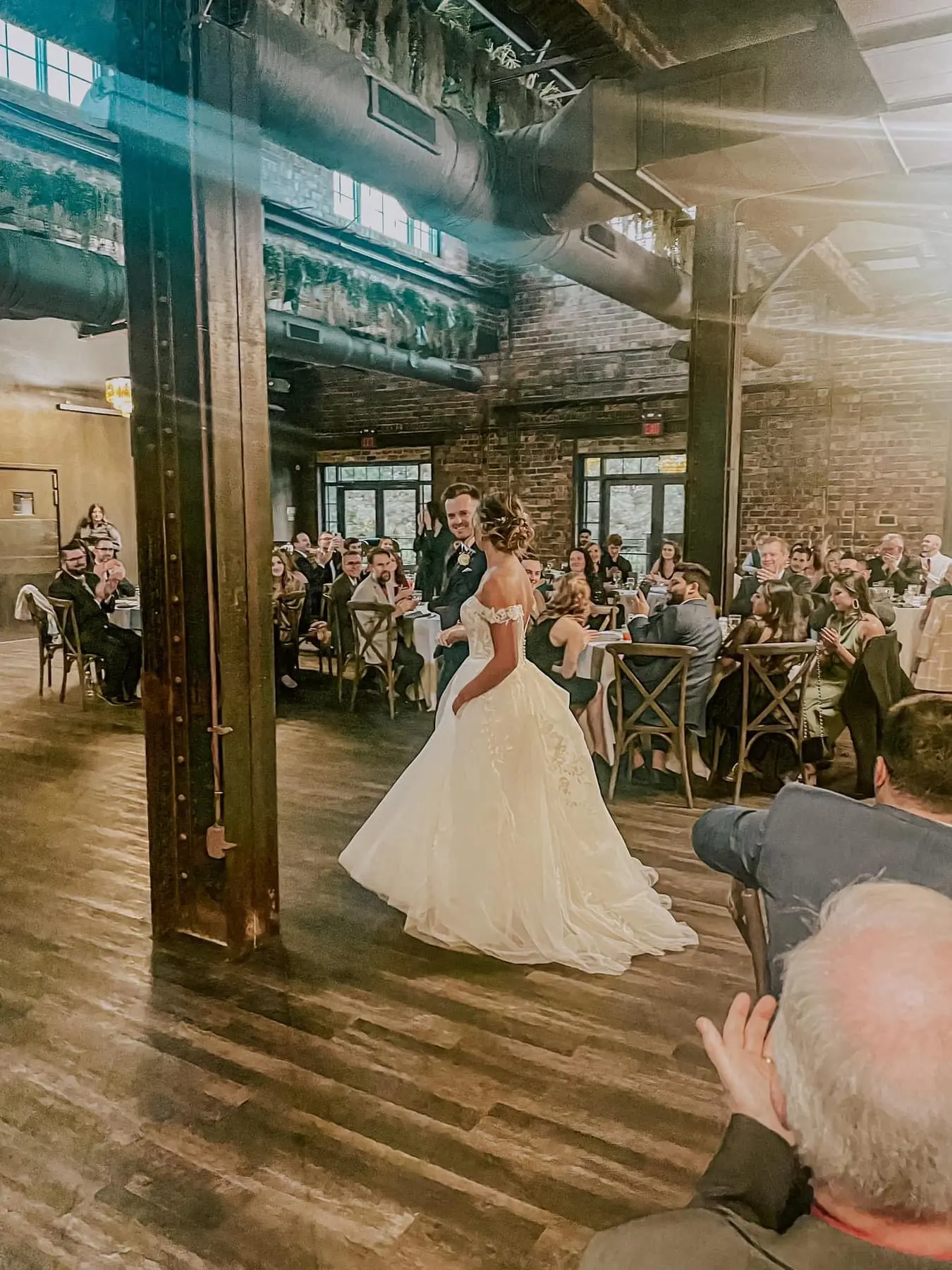 Bride wearing Harlem wedding dress by Maggie Sottero dancing with her husband