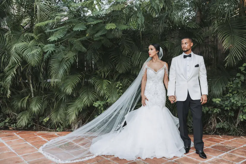 Bride with groom wearing glamorous mermaid wedding dress
