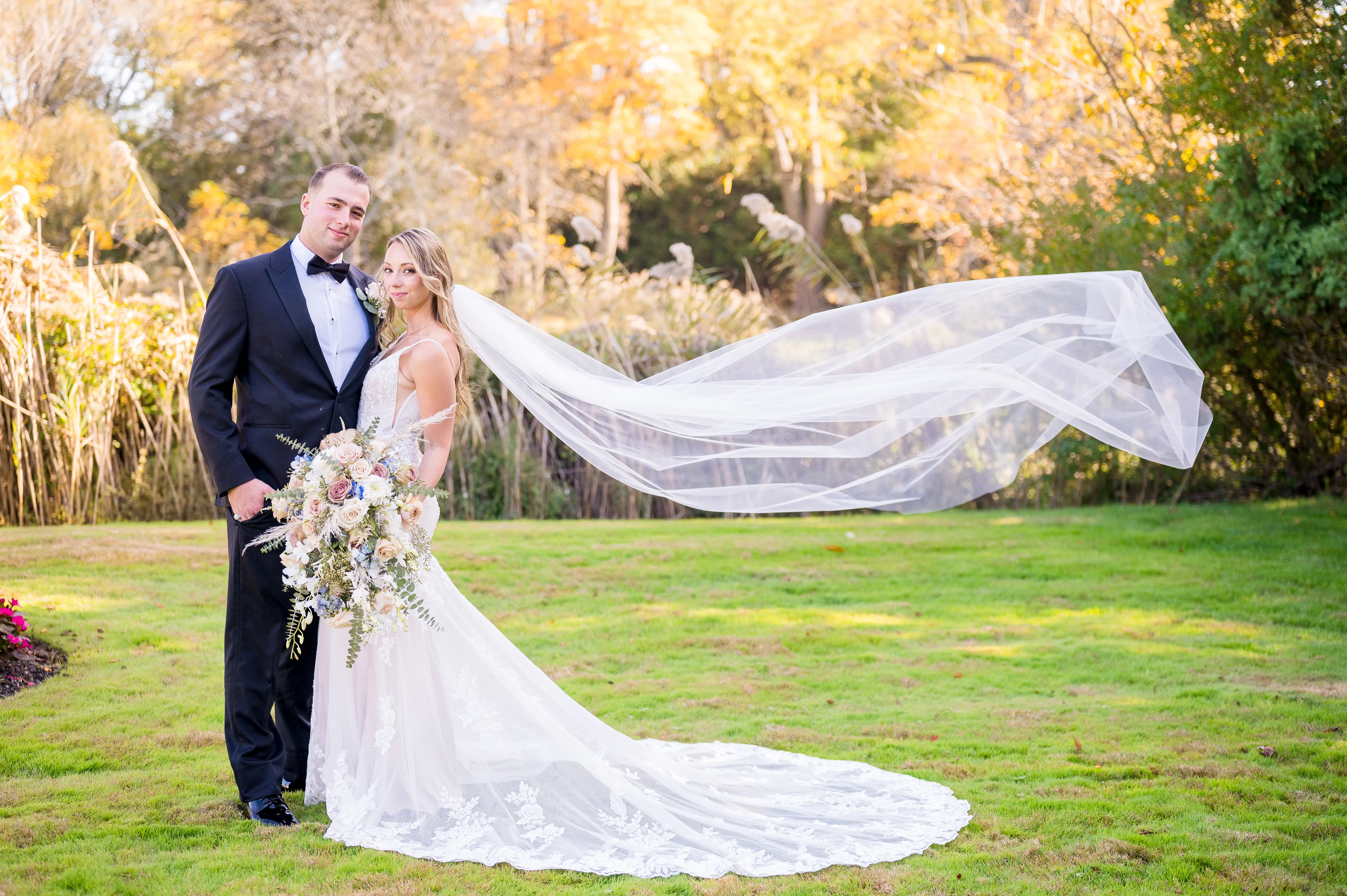 Real bride in sparkly lace fit-and-flare bridal gown with lace motifs over tulle called Fontaine by Maggie Sottero