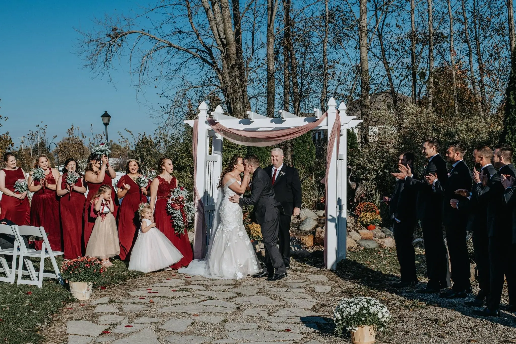 Groom Kisses the Bride in Strapless Mermaid Bridal Gown with Sweetheart Neckline Called Hattie by Rebecca Ingram