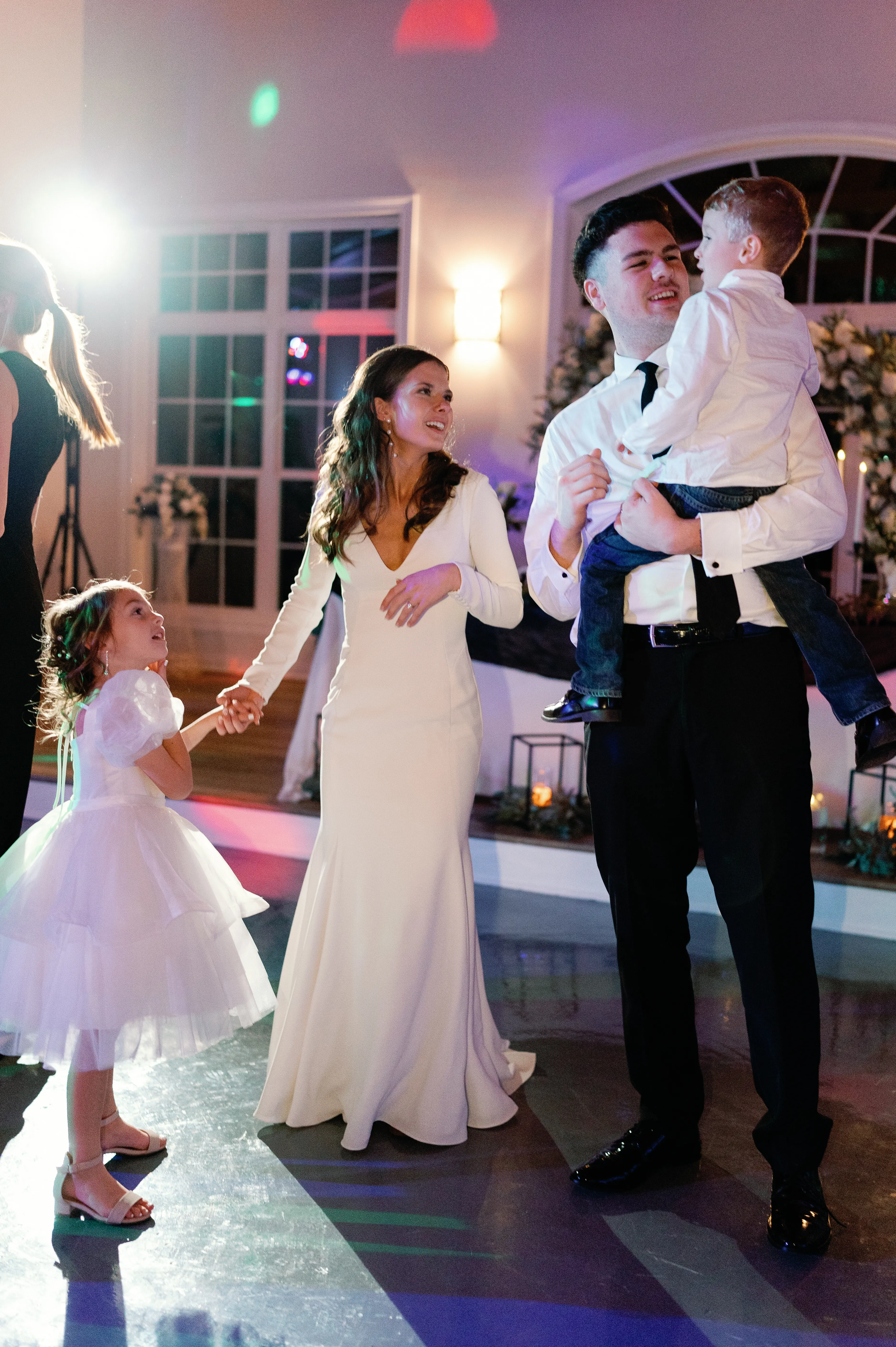 Bride wearing Fernanda wedding dress by Maggie Sottero dancing with her family