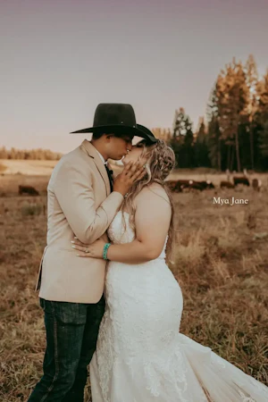 Bride wearing Frederique Royale wedding dress by Maggie Sottero kissing husband