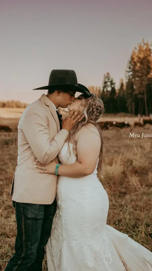Bride wearing Frederique Royale wedding dress by Maggie Sottero kissing husband