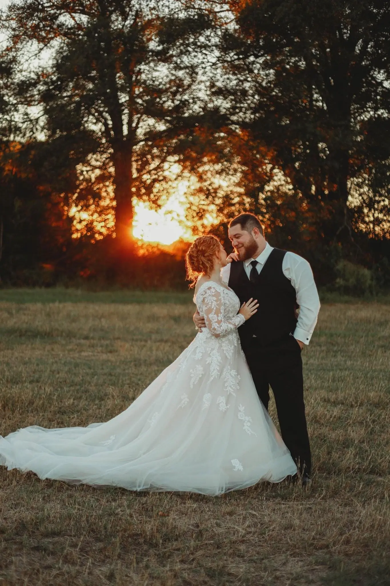 Bride And Groom Standing Together. Bride Wearing Illusion Sleeve A-line Wedding Dress Called Raphael By Maggie Sottero