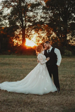 Bride And Groom Standing Together. Bride Wearing Illusion Sleeve A-line Wedding Dress Called Raphael By Maggie Sottero
