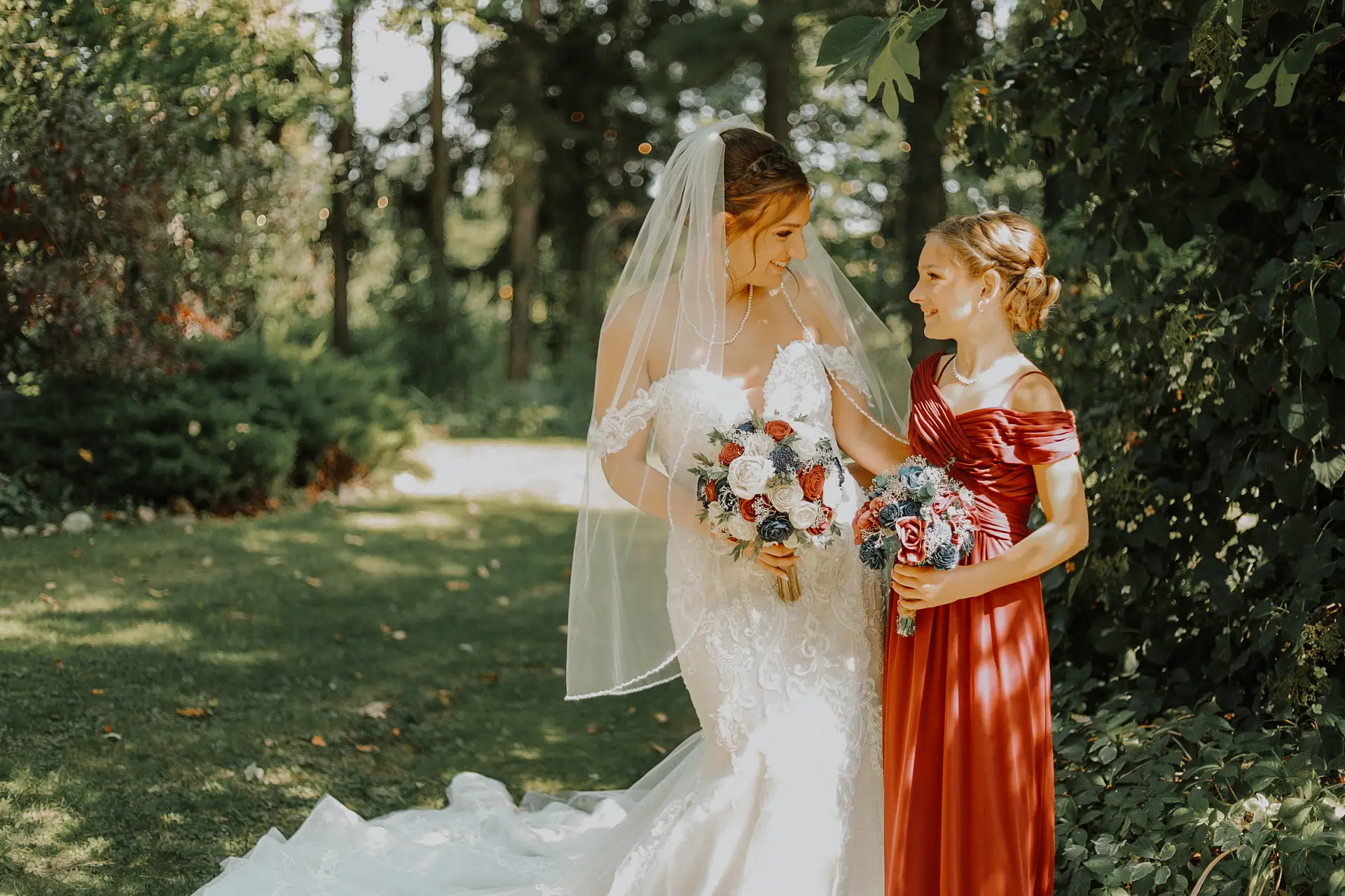 Bride wearing Marguerite wedding dress by Maggie Sottero with a flower girl