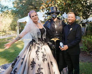 Bride Wearing Black Lace Wedding Dress Called Norvinia By Sottero And Midgley With Groom And Plague Doctor