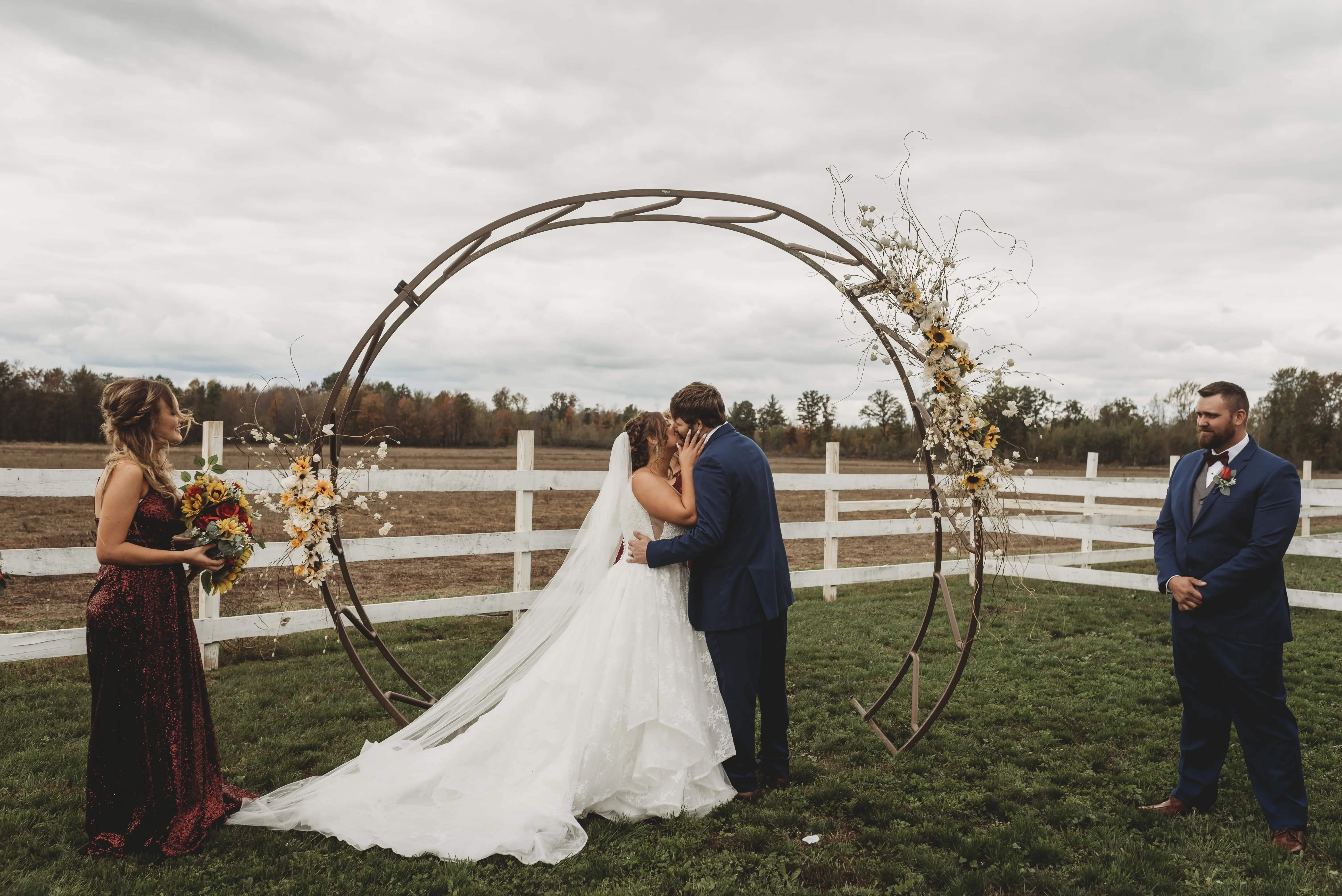 Bride In Lace Ruffled Wedding Dress Called Yuri By Maggie Sottero At Wedding Ceremony With Groom
