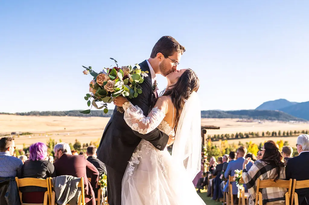Bride with groom wearing boho A-line wedding dress