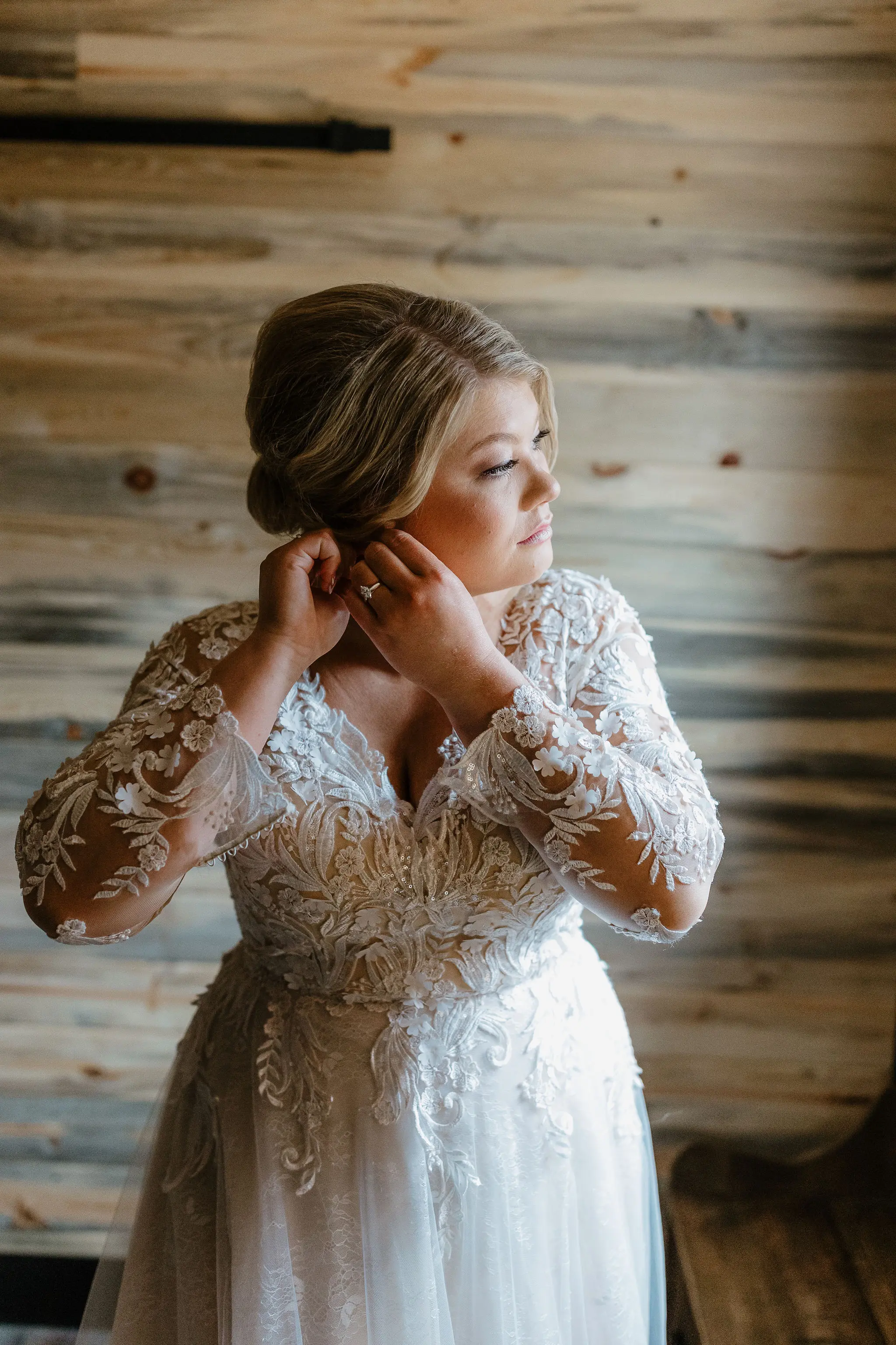 Bride Getting Ready Wearing Long Sleeve Ballgown With Plunging Neckline Called Zander By Sottero And Midgley