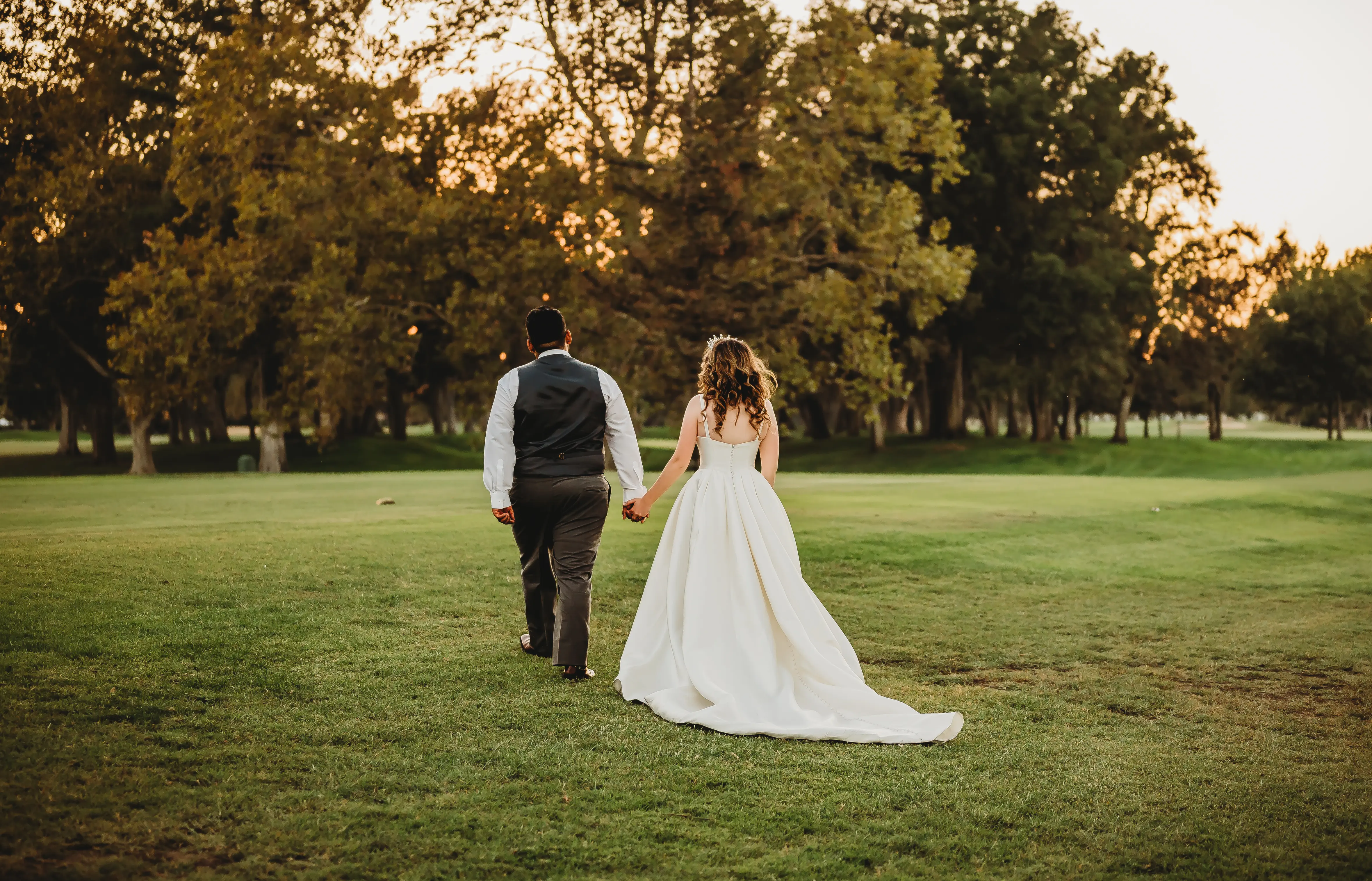 Bride And Groom Walking Together. Bride In Satin A-Line Wedding Dress Called Selena By Maggie Sottero