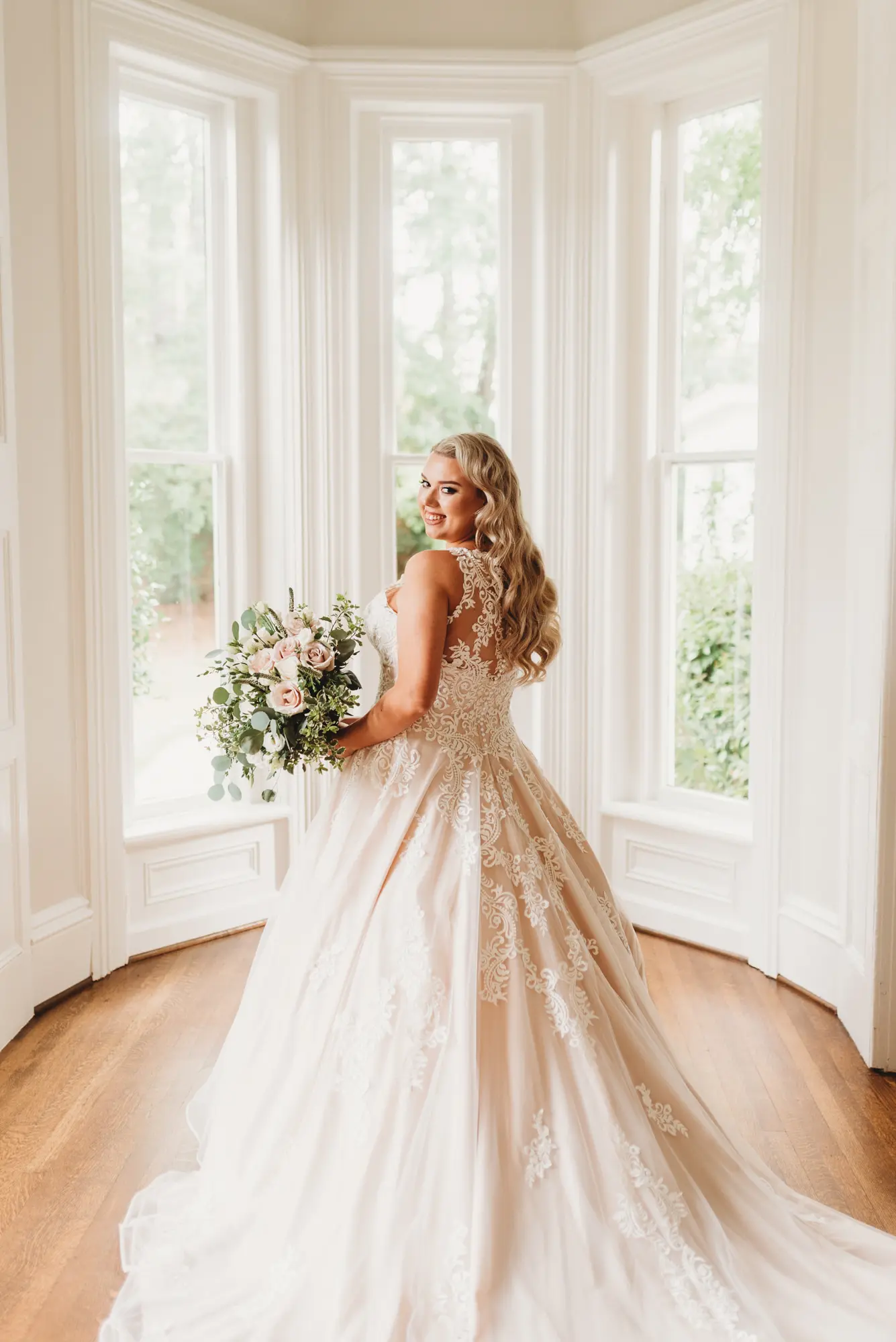 Bride wearing a plus size ballgown wedding dress.
