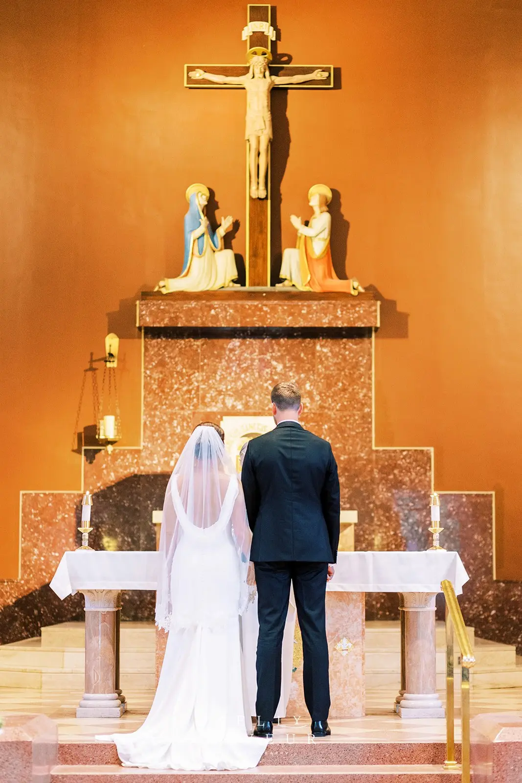 Bride wearing simple crepe wedding dress Bertina by Maggie Sottero.