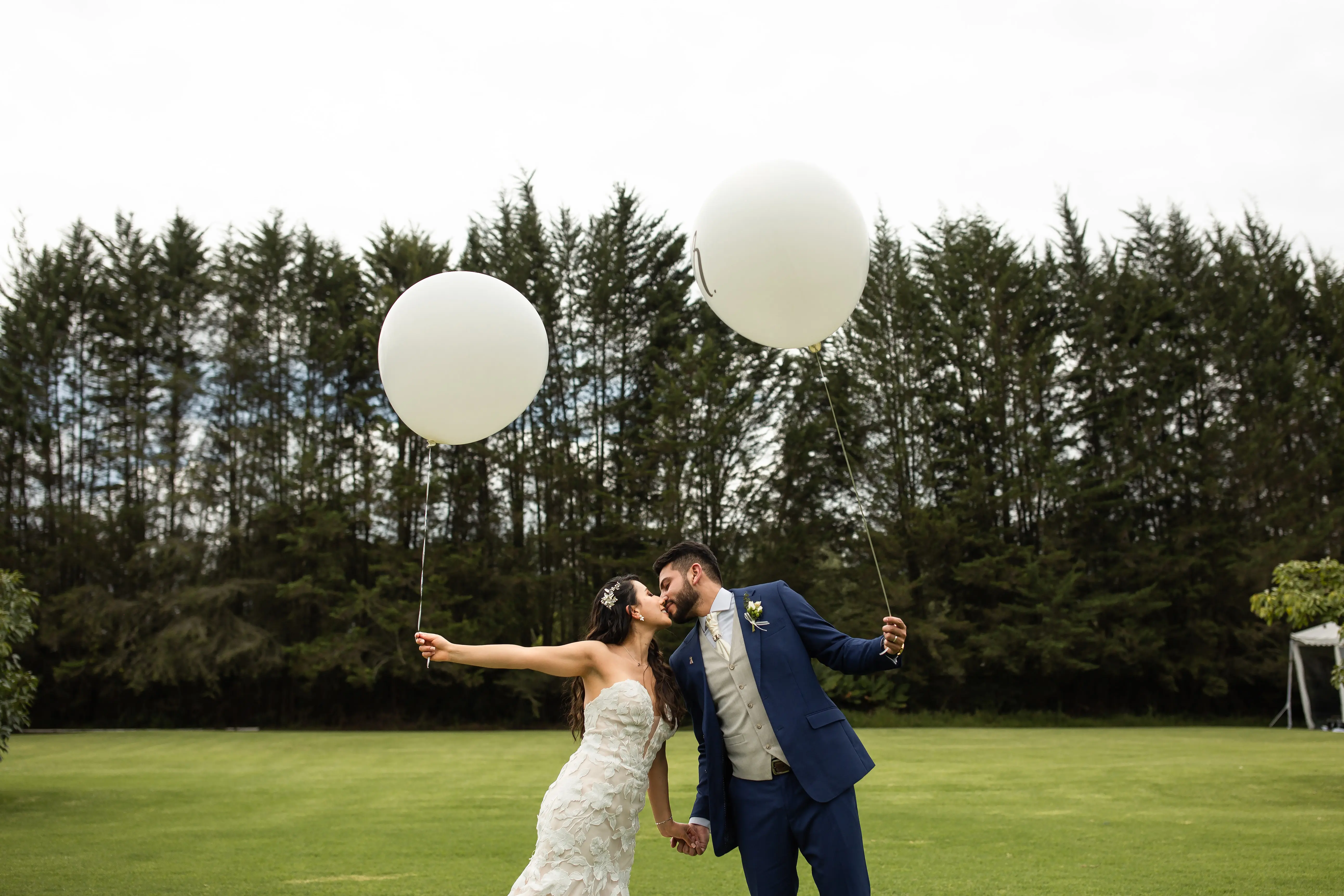 Bride with groom wearing affordable, strapless mermaid wedding dress.