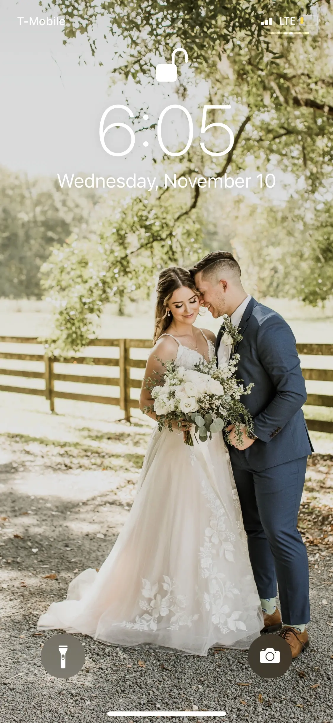 Bride with groom wearing affordable floral ballgown wedding dress.