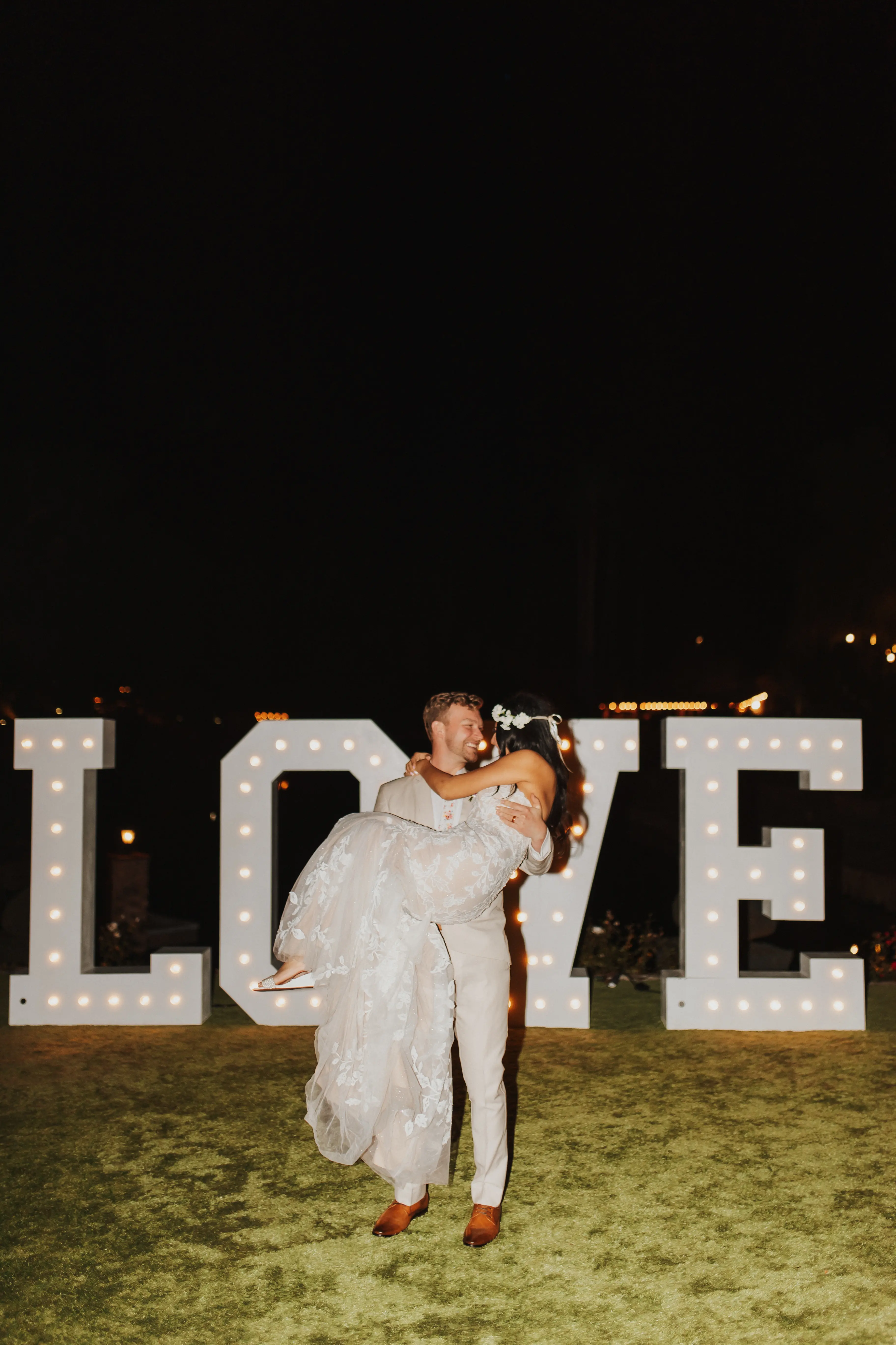 Bride In Lace Wedding Dress Called Ivy By Maggie Sottero With Groom In Front Of LOVE Sign