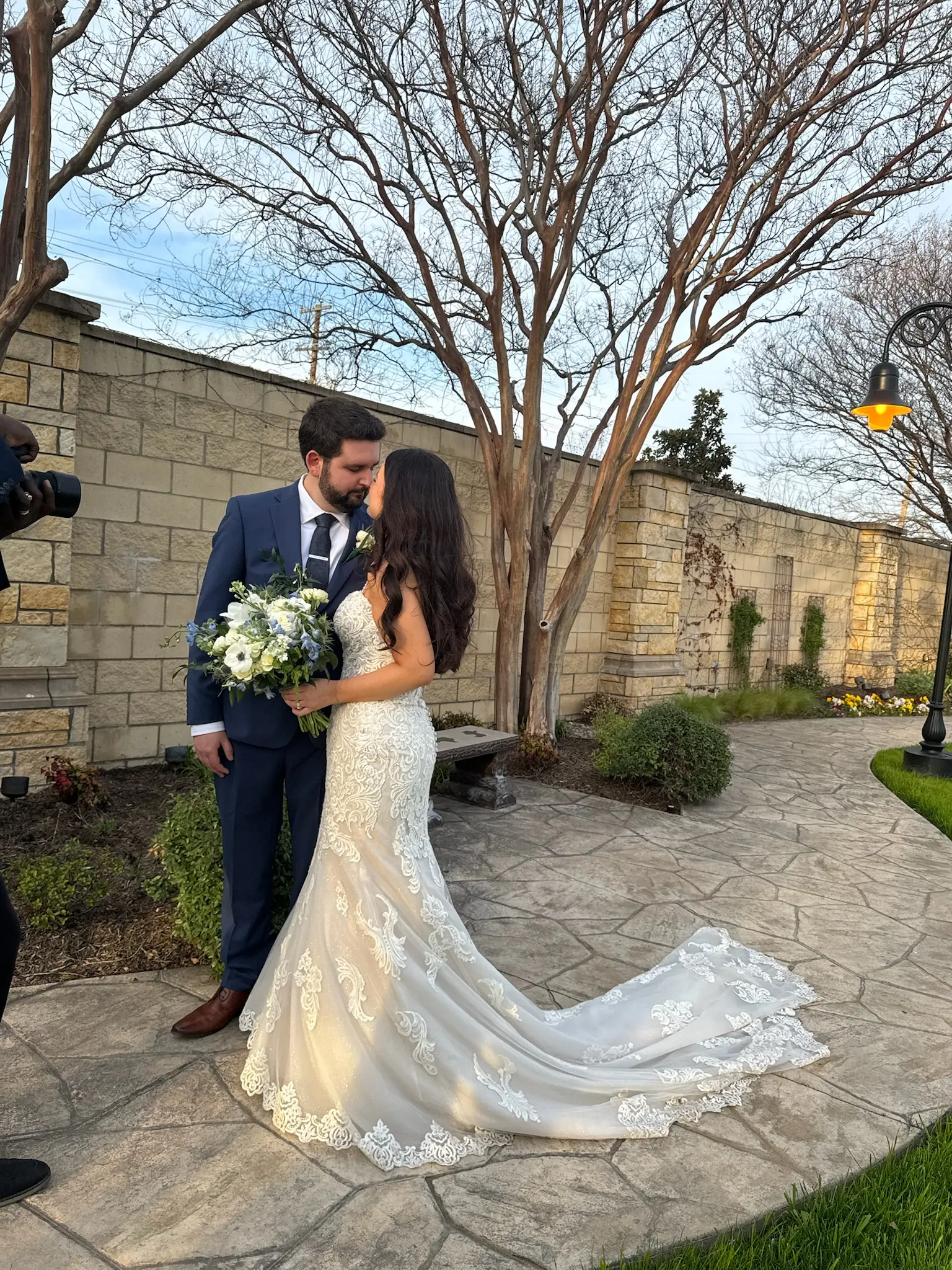 Bride Wearing Fit-n-Flare Wedding Dress Called Fiona By Maggie Sottero Kissing Groom