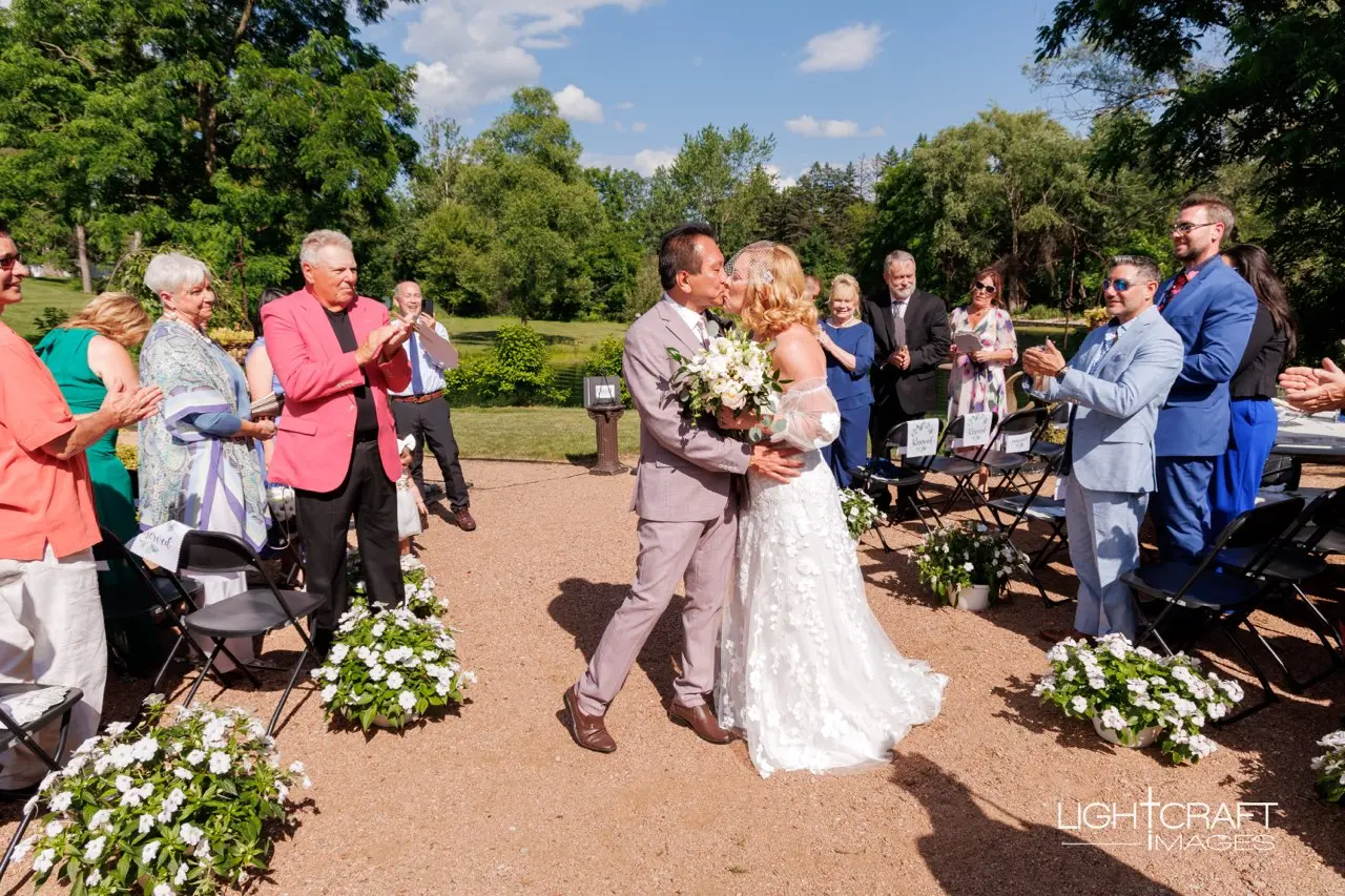 Bride wearing Demetria by Maggie Sottero kissing her husband at their ceremony