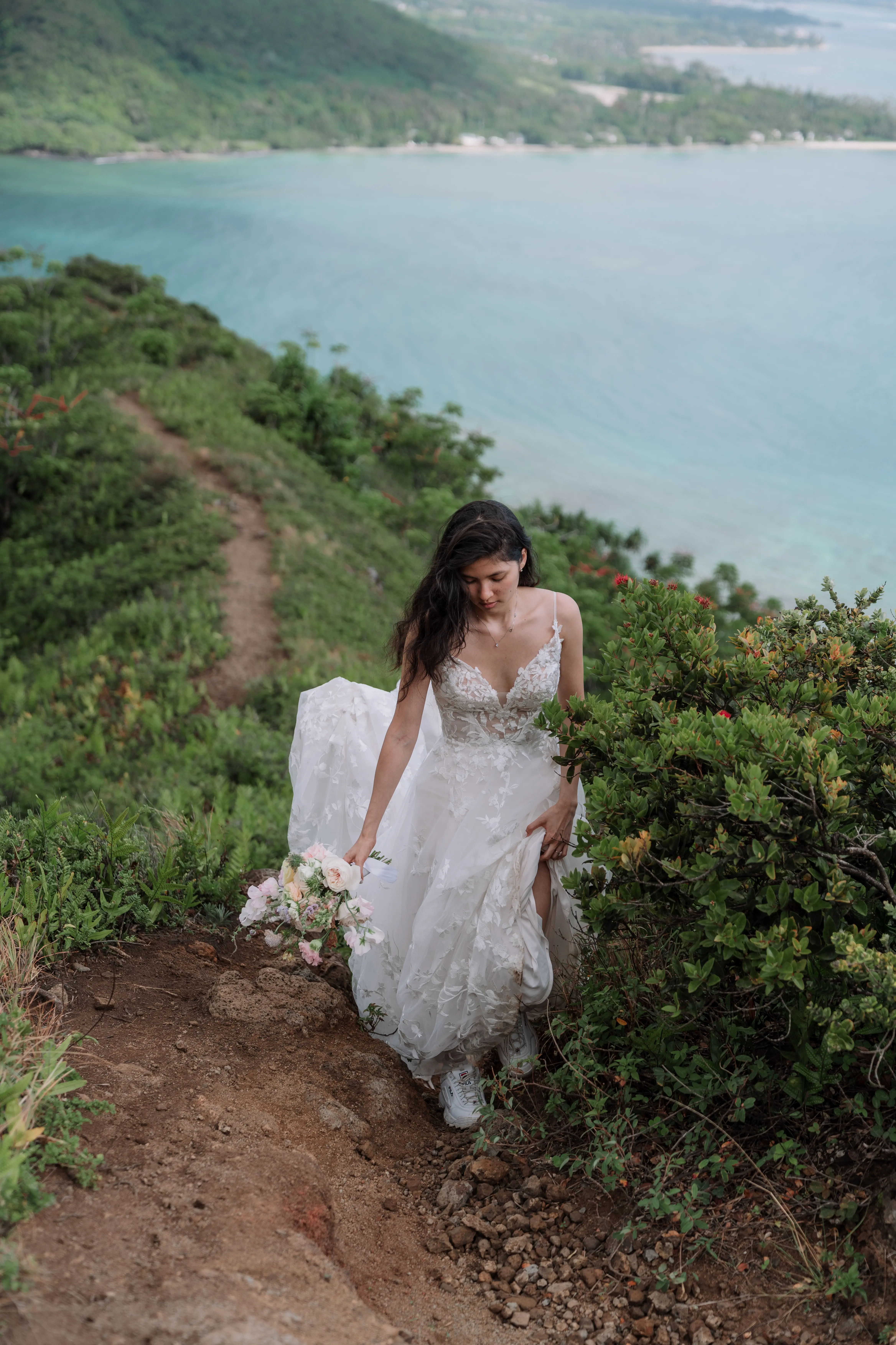 Bride wearing Winter wedding dress by Maggie Sottero hiking