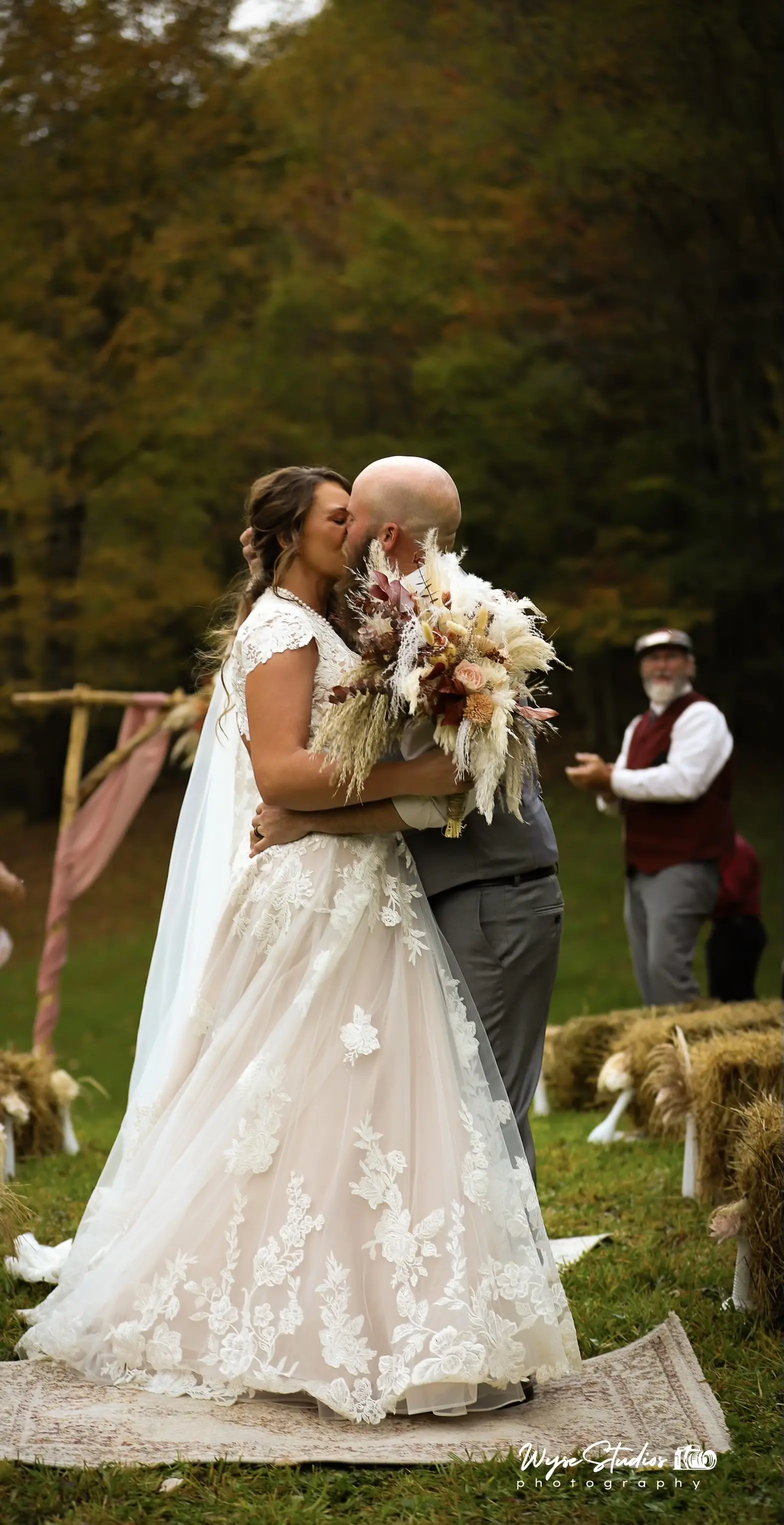 Bride wearing Kingsley wedding gown by Sottero and Midgley kissing her husband