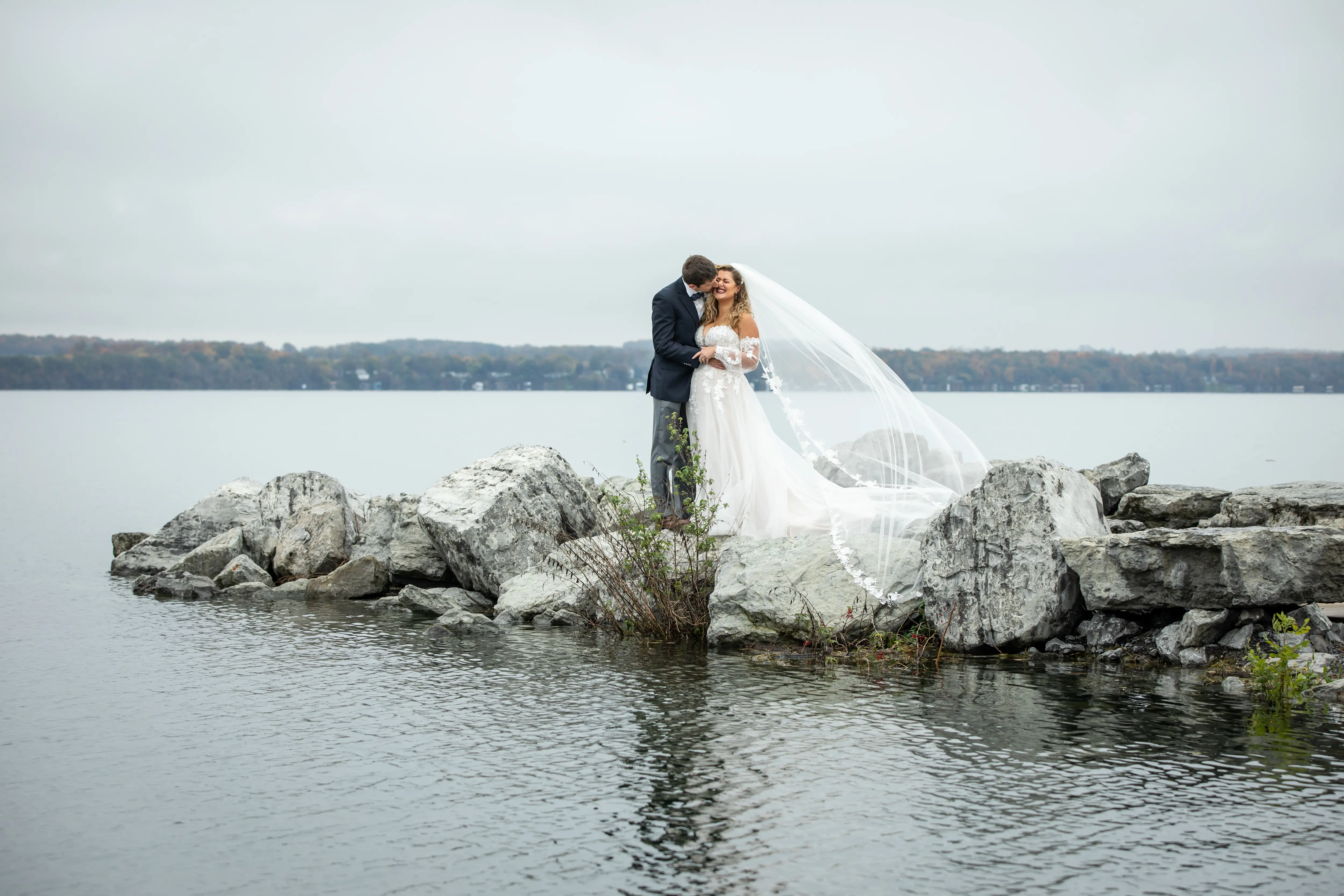 Groom Kissing Bride Wearing Boho A-Line Wedding Dress Called Stevie By Maggie Sottero