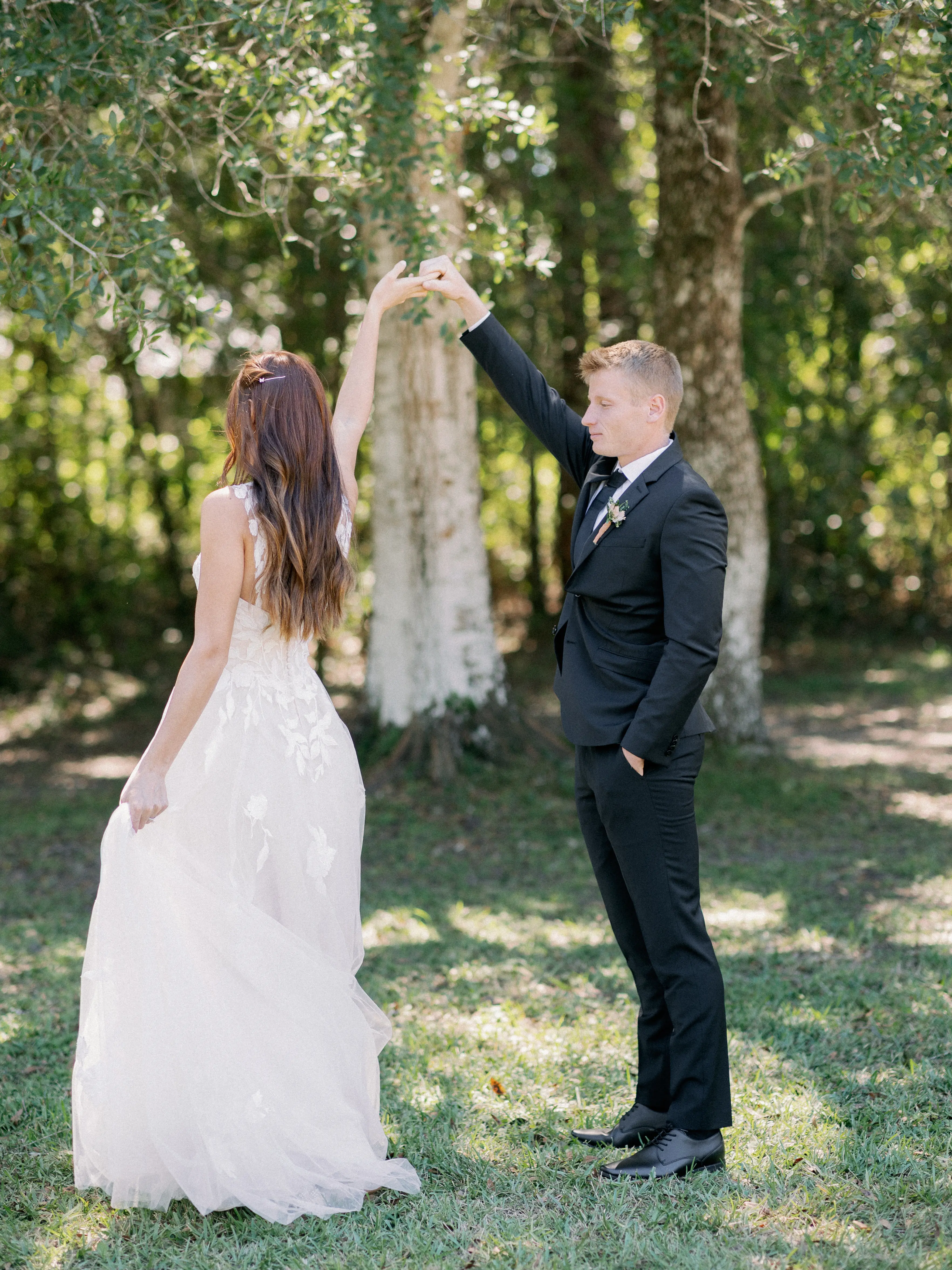 Bride Wearing Plunging V-Neckline Bridal Dress Named Hattie Lane Marie By Rebecca Ingram Bride Twirling With Groom