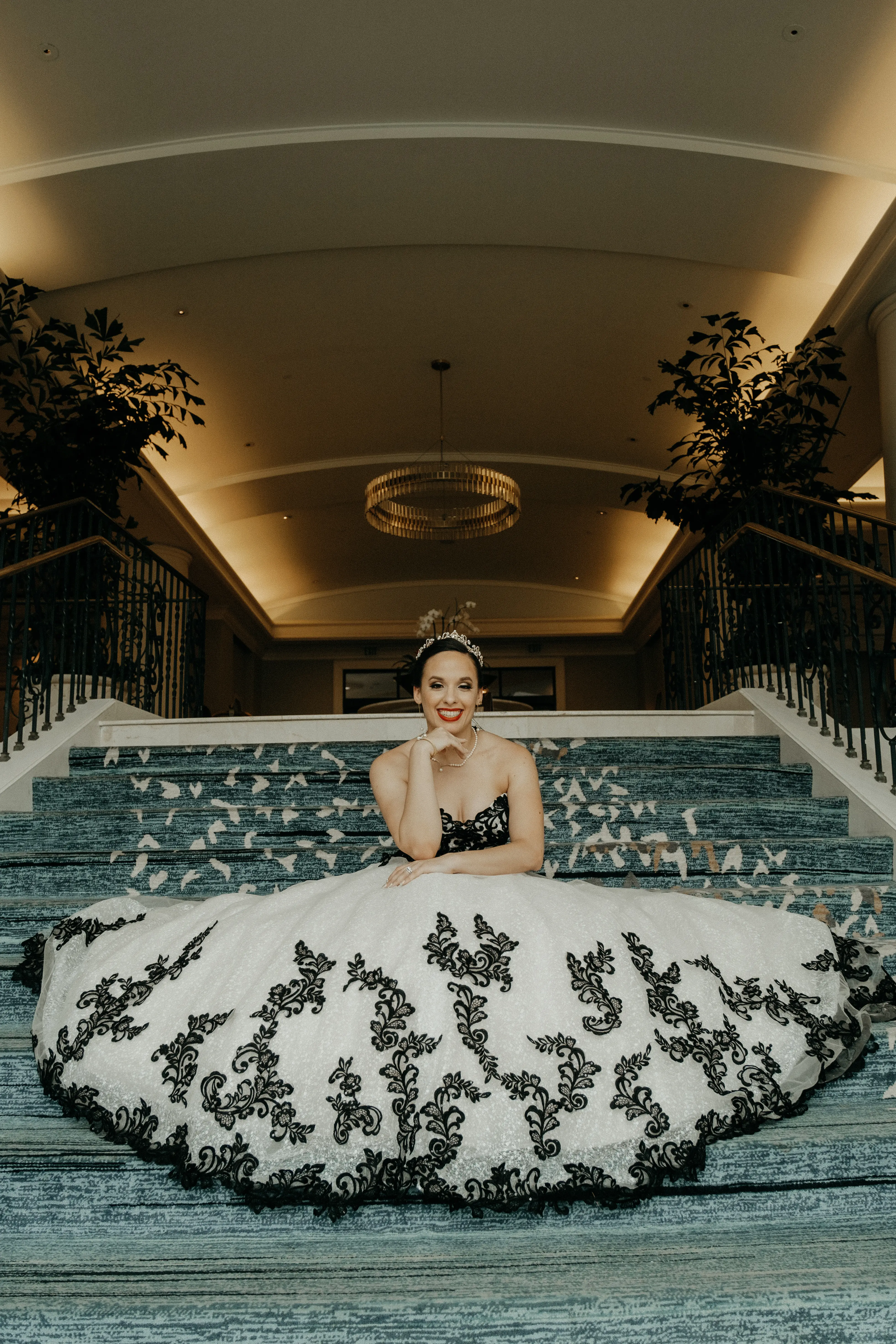 Bride wearing Tristyn wedding dress by Maggie Sottero sitting on stairs