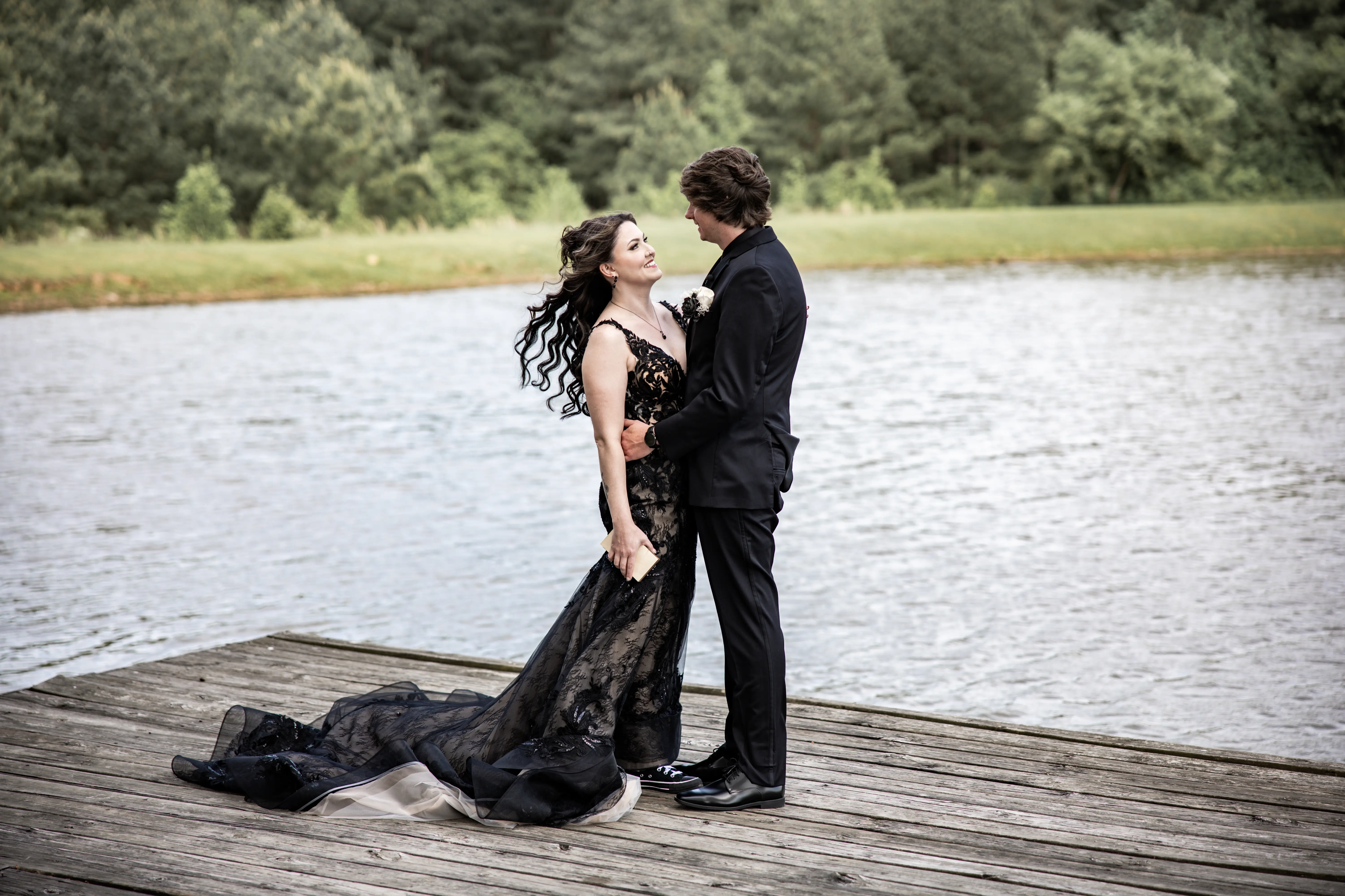 Bride wearing Zander Lane by Sottero and Midgley on a dock with her husband