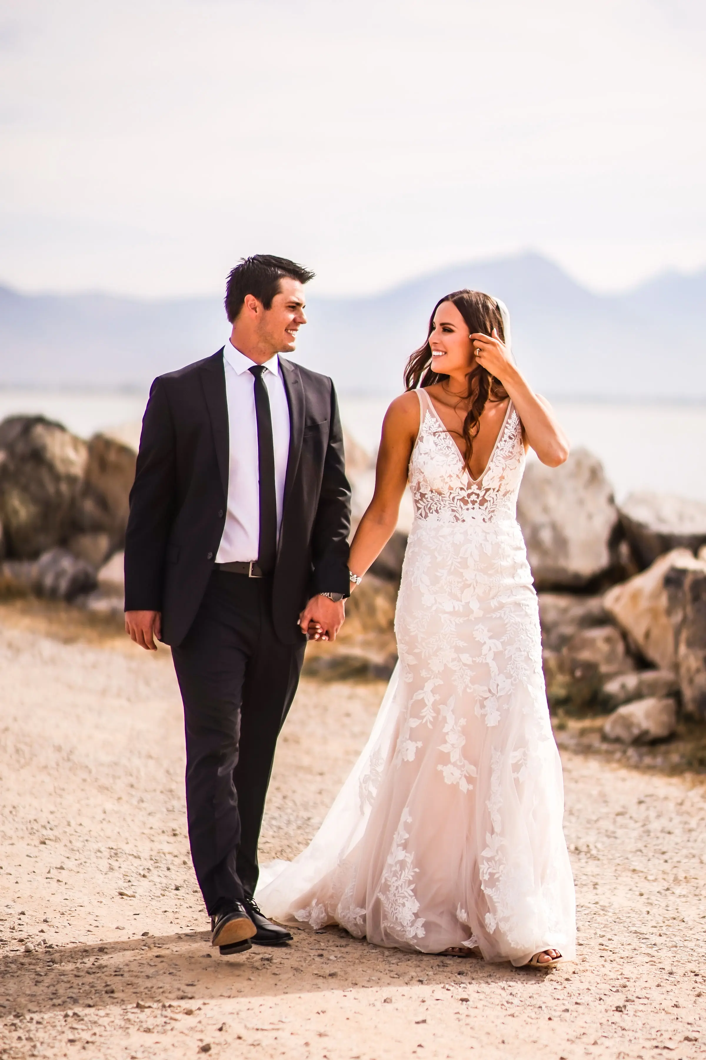 Groom with bride wearing sexy fit and flare wedding dress called Greenley by Maggie Sottero.