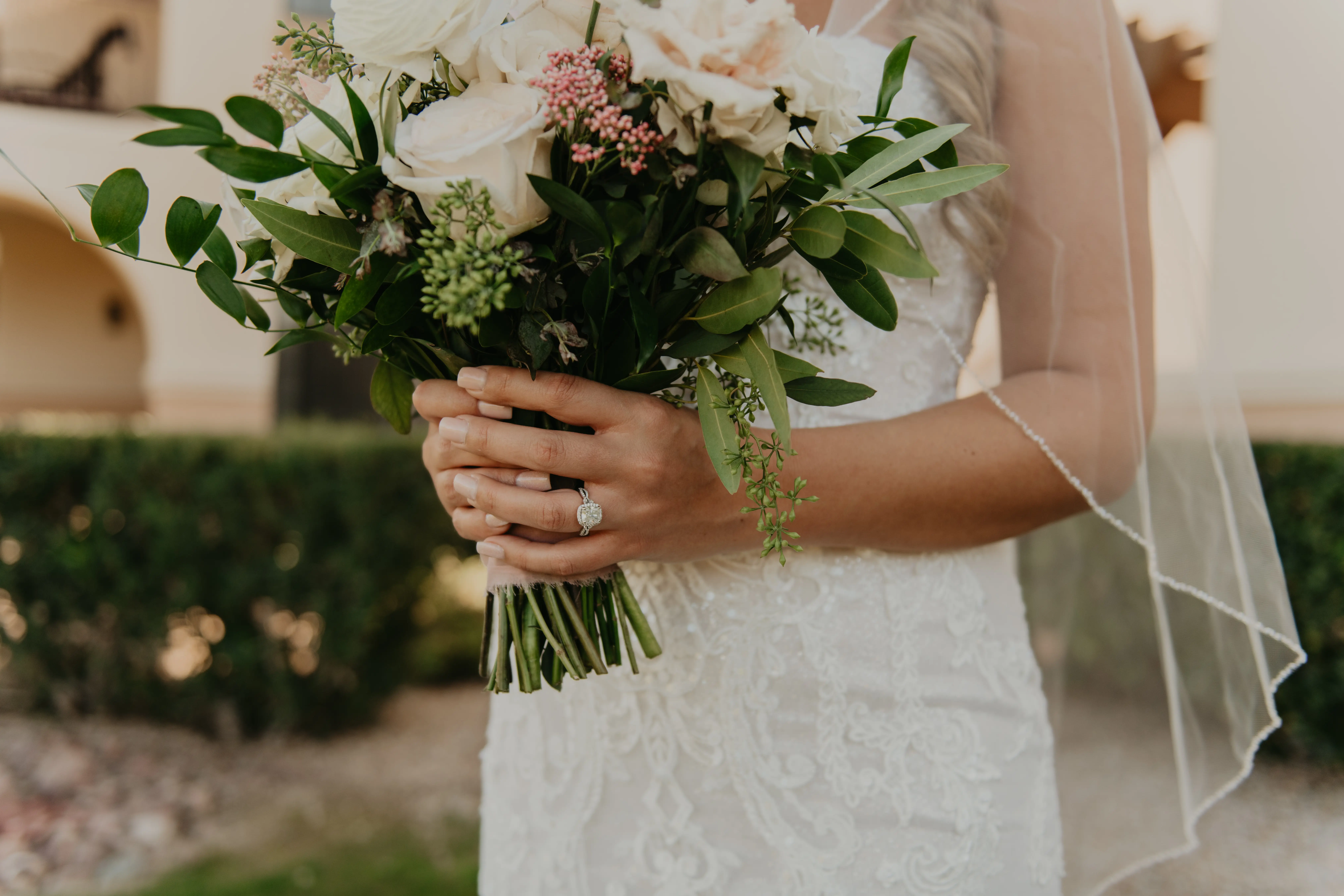 Bride Holds Bouquet in Front of Detailed Lace Wedding Dress Frederique by Maggie Sottero
