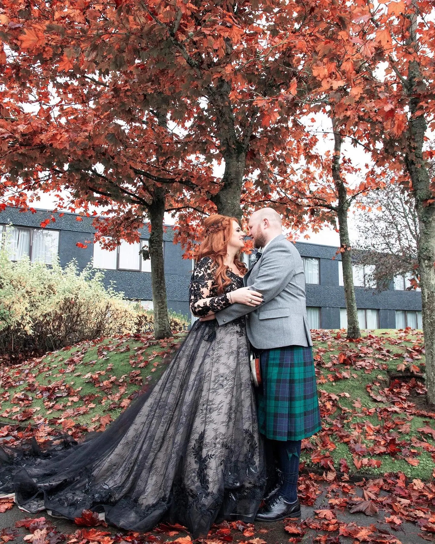 Bride wearing Black Wedding Dress called Zander by Sottero and Midgley and Groom standing by fall trees