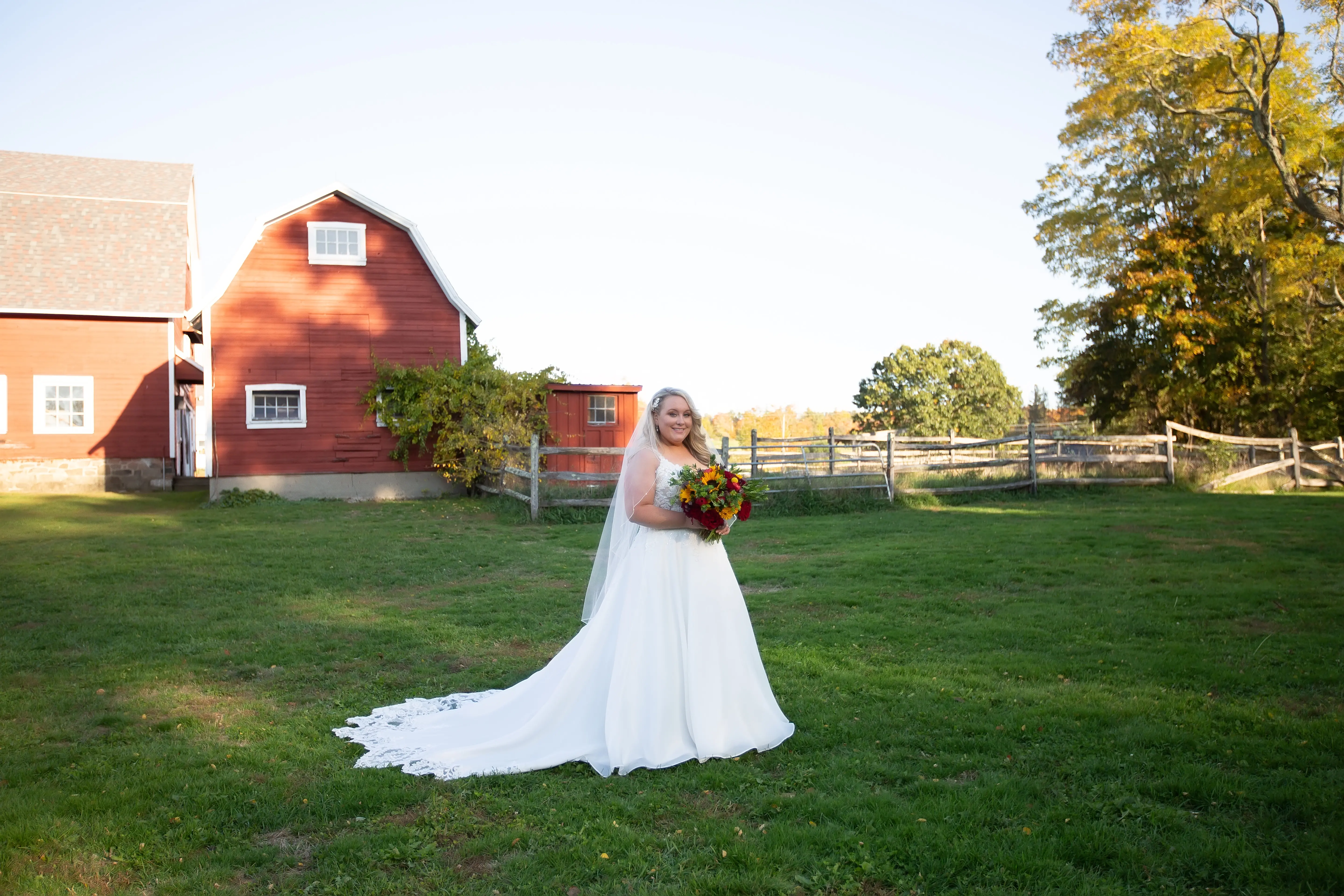 Bride Standing in Barn Feild in Savannah Wedding Dress Called Savannah by Maggie Sottero.