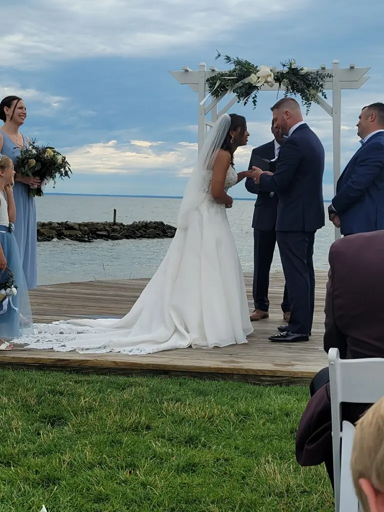 Groom and Bride at a Beach Wedding Exchanging Vows Wearing Lace Aline Wedding Dress called Savannah by Maggie Sottero