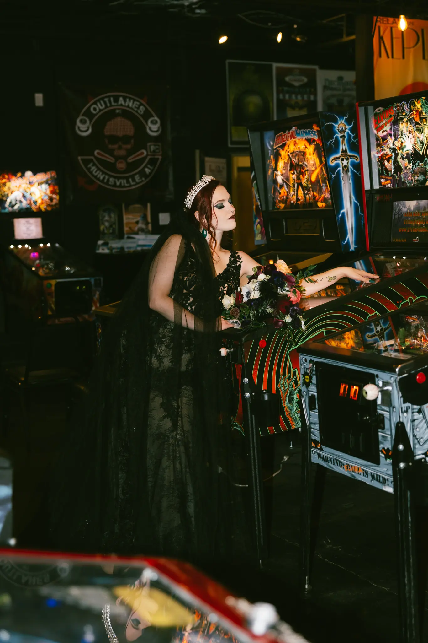 Bride Wearing Black Lace Wedding Dress Called Zander Lane By Sottero And Midgley Next To Arcade Games