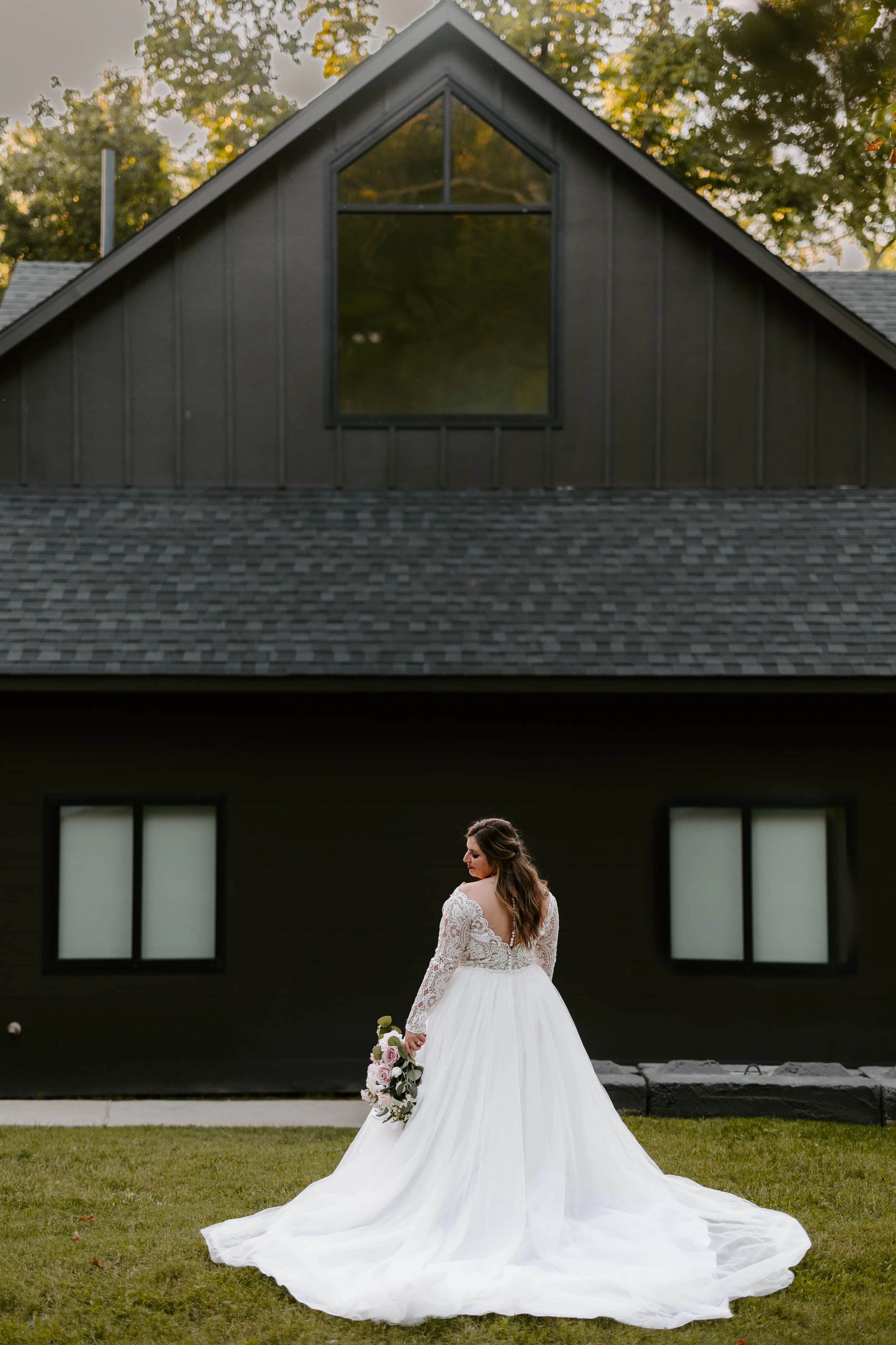 Bride Wearing Princess Wedding Dress Called Mallory Dawn By Maggie Sottero Near A Black Building