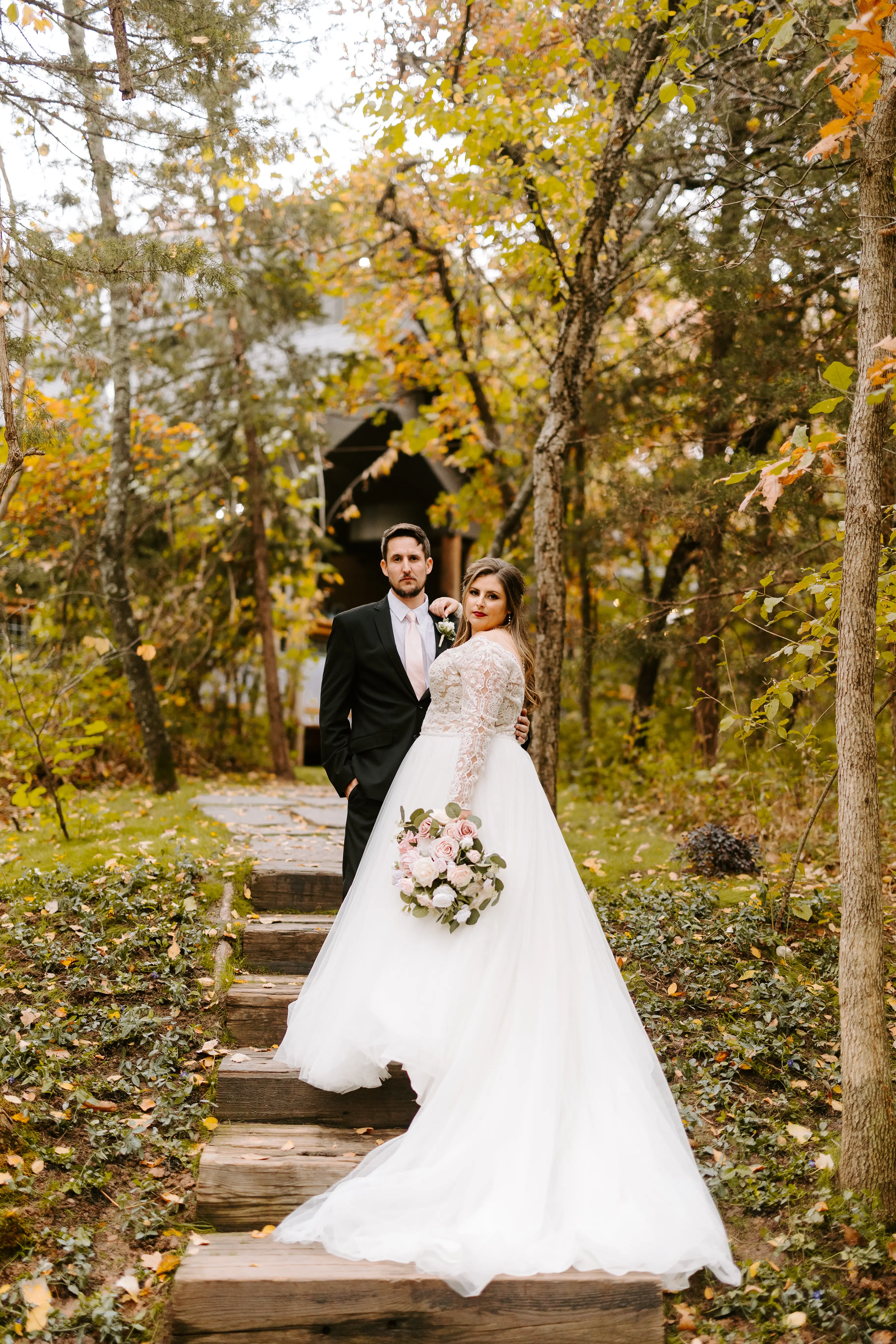 Bride Wearing Princess Wedding Dress Called Mallory Dawn By Maggie Sottero With Groom On Wooden Steps